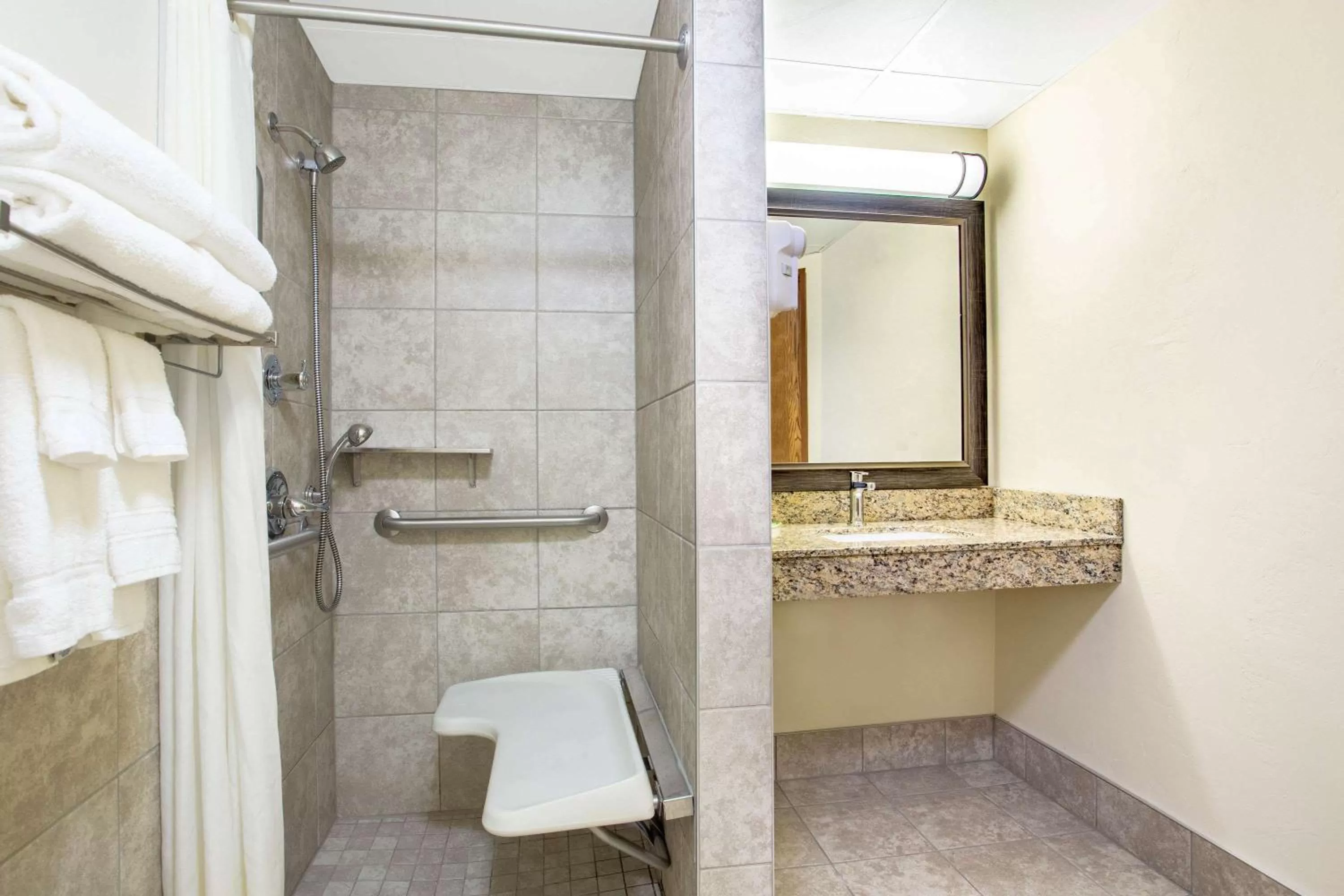 Shower in AmericInn by Wyndham Green Bay West