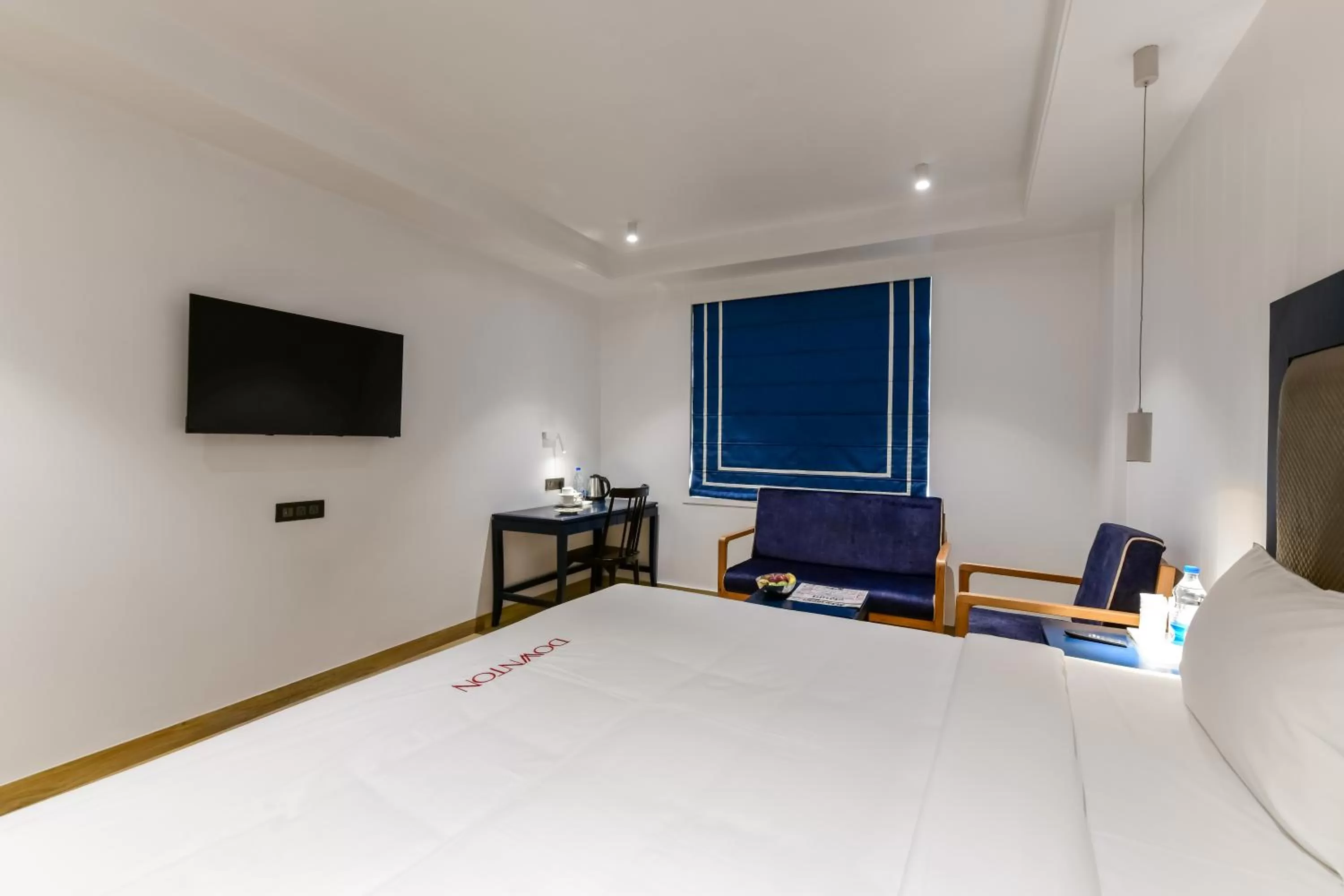 Bed, TV/Entertainment Center in The Downton Hotel