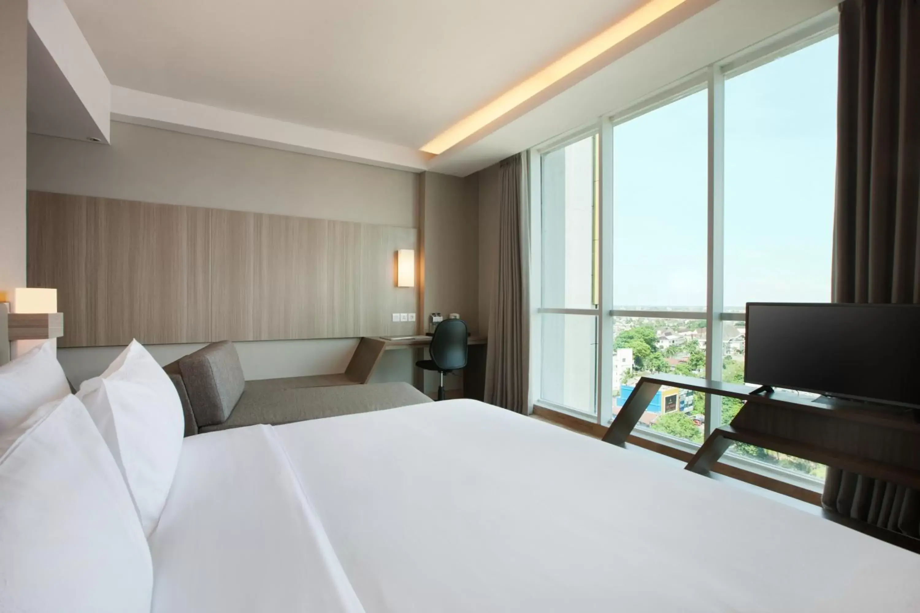 Photo of the whole room, Bed in Hotel Santika Radial Palembang