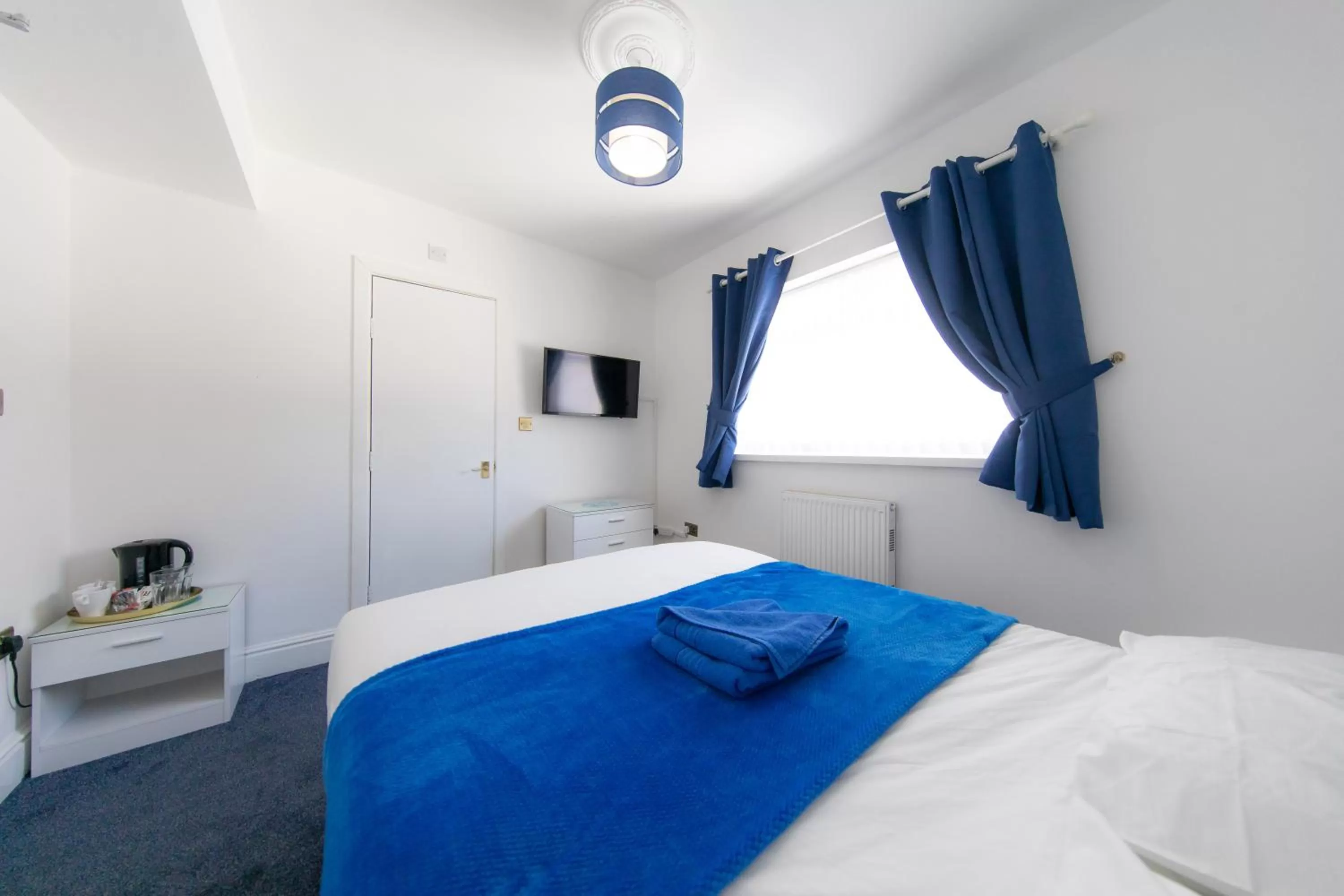 Communal lounge/ TV room, Bed in The Adonis Hotel