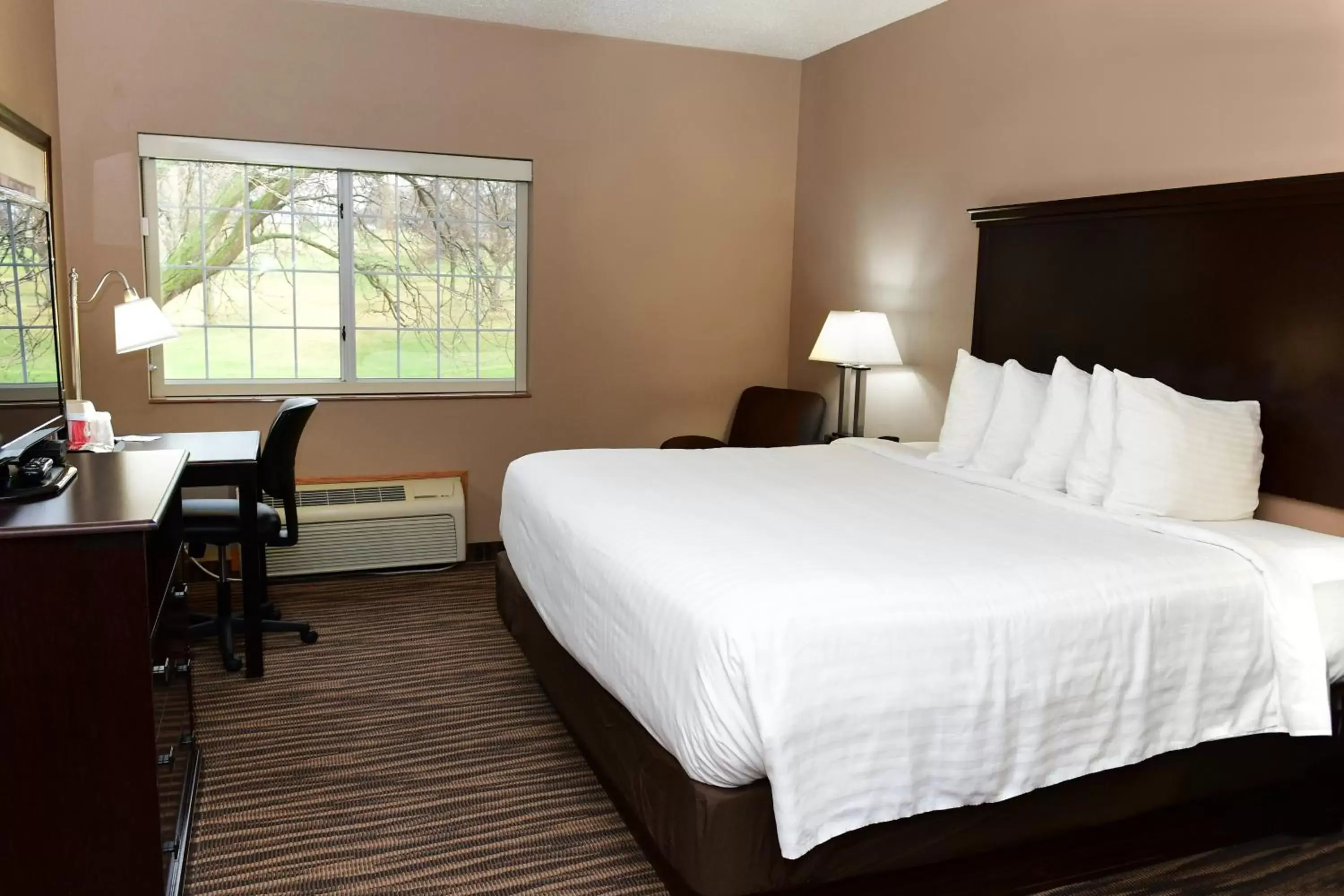 Bed in Cobblestone Inn & Suites - Denison | Majestic Hills