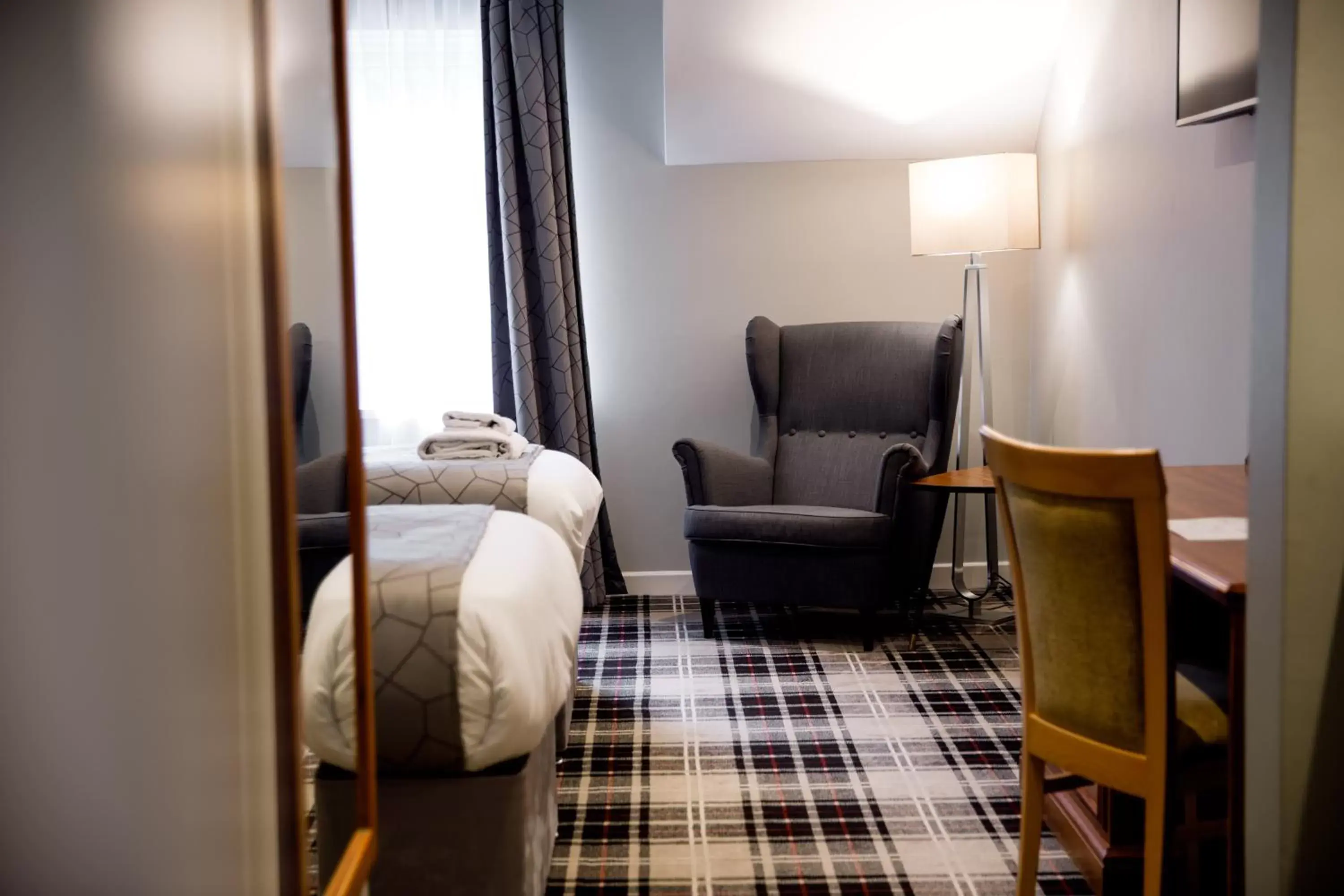 Bed, Seating Area in The Heritage Park Hotel