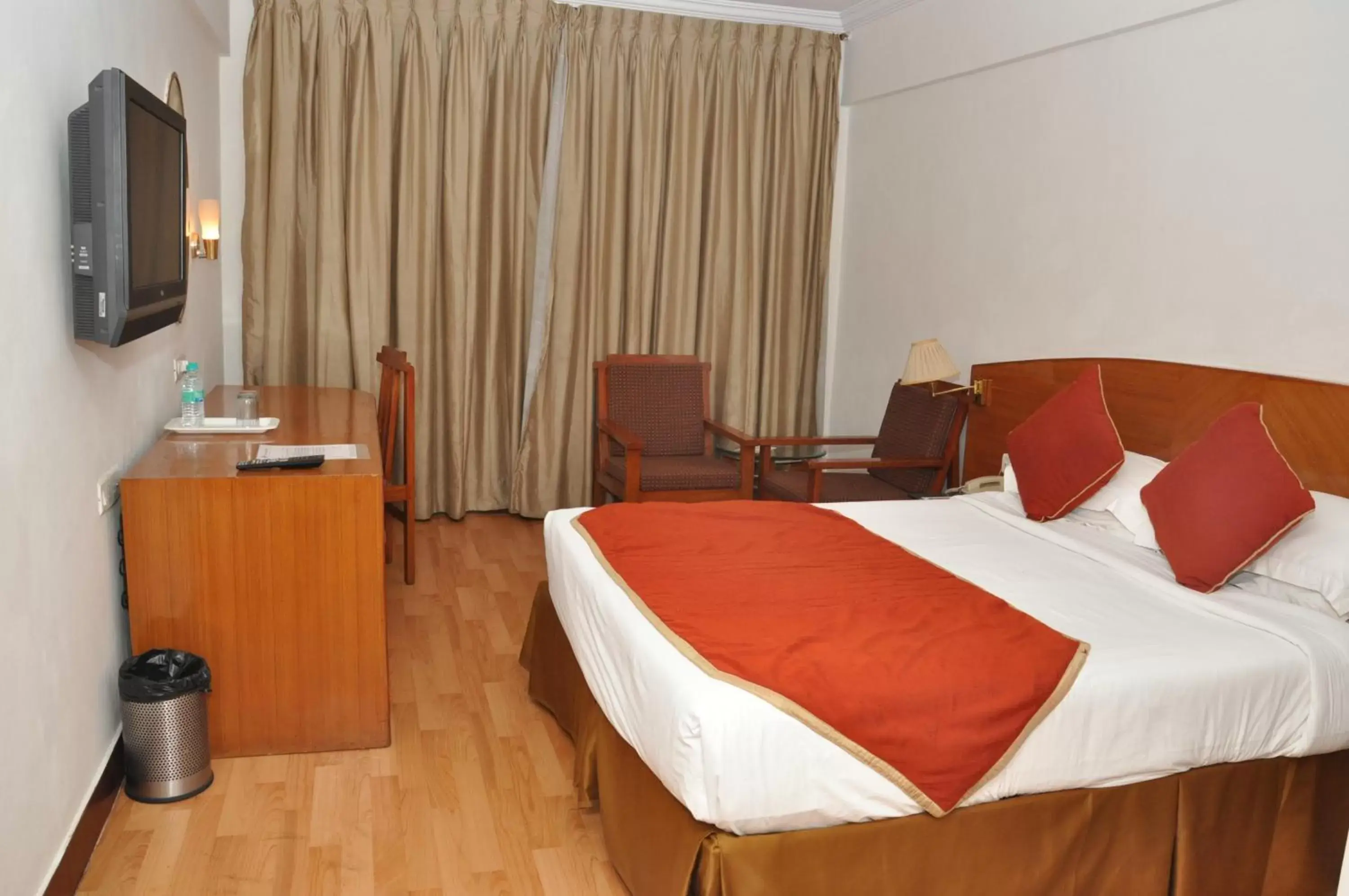 Photo of the whole room, Bed in Ramee Guestline Tirupati