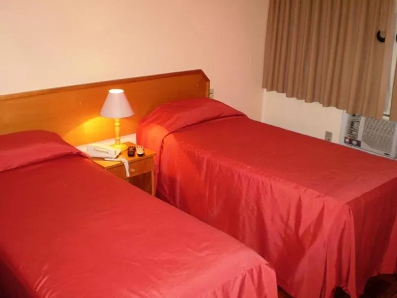 Bed in Hotel Gravataí Center