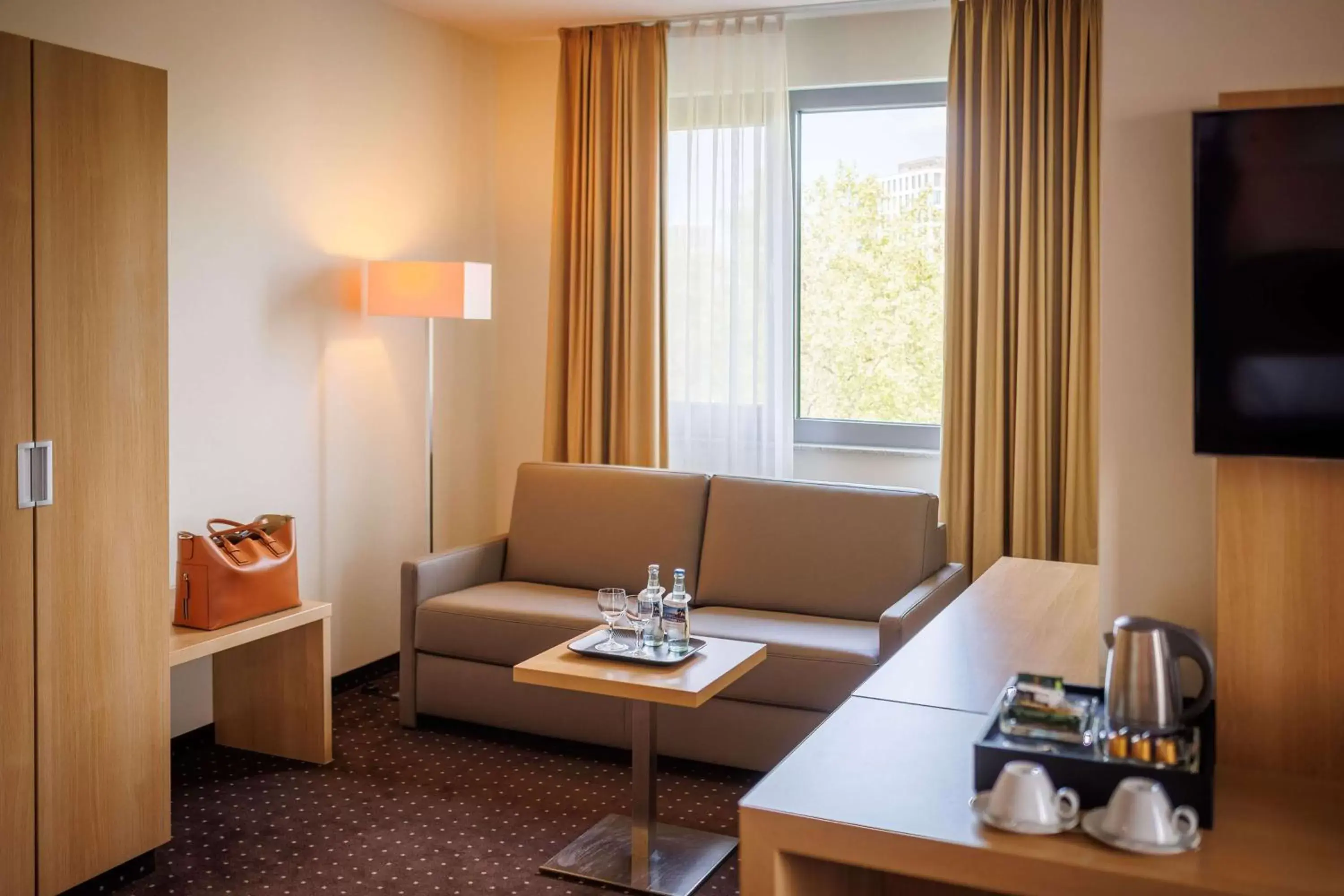 Bedroom, Seating Area in Lanzcarré Hotel Mannheim, a member of Radisson Individuals