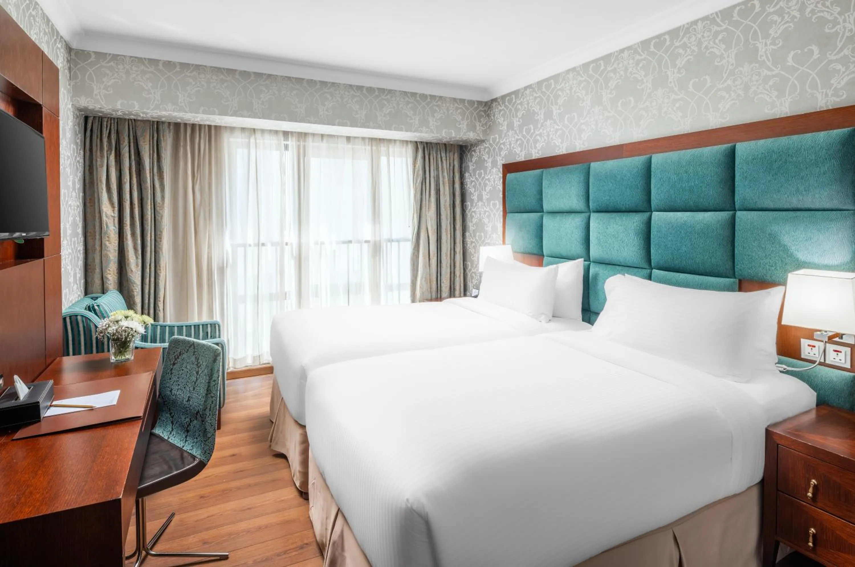 Bed in Millennium Al Aqeeq Hotel