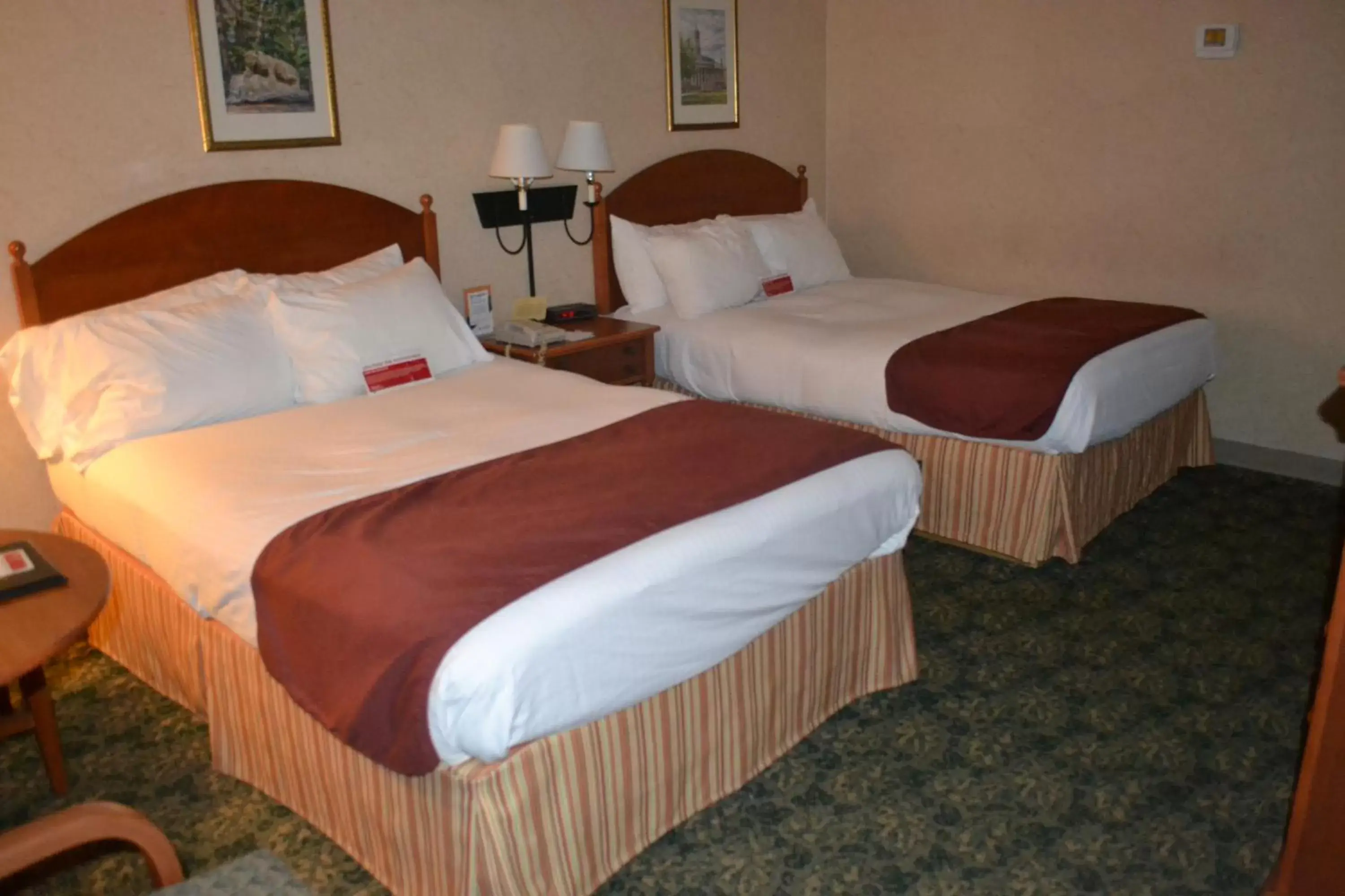 Bed in Ramada by Wyndham State College Hotel & Conference Center