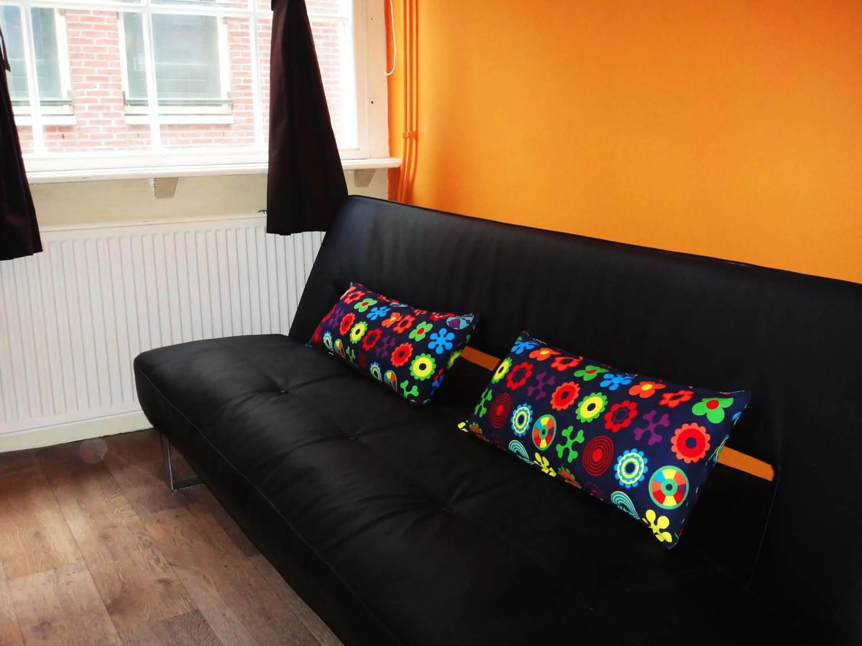 Bed, Seating Area in Orange Suite Studio