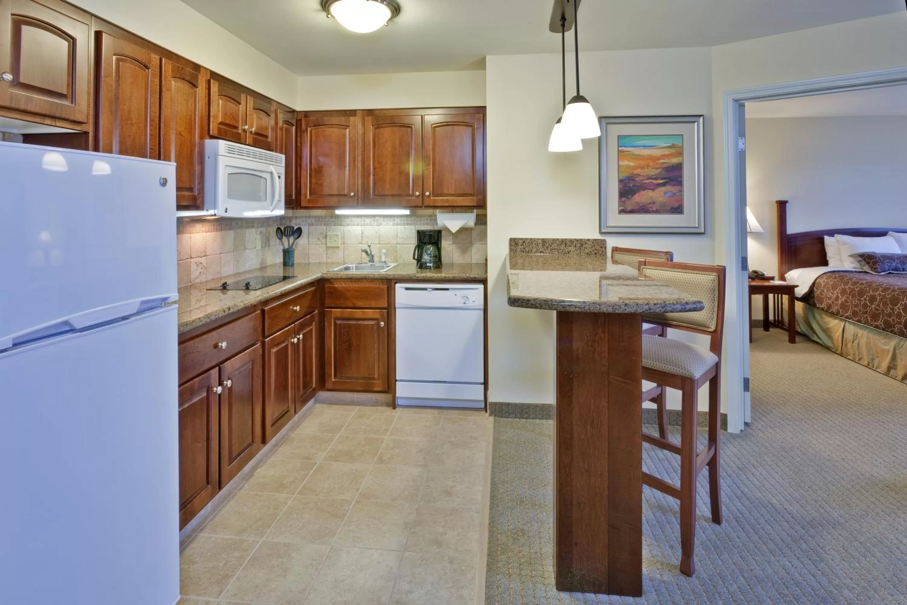 Kitchen or kitchenette, Bed in Staybridge Suites Indianapolis-Carmel by IHG