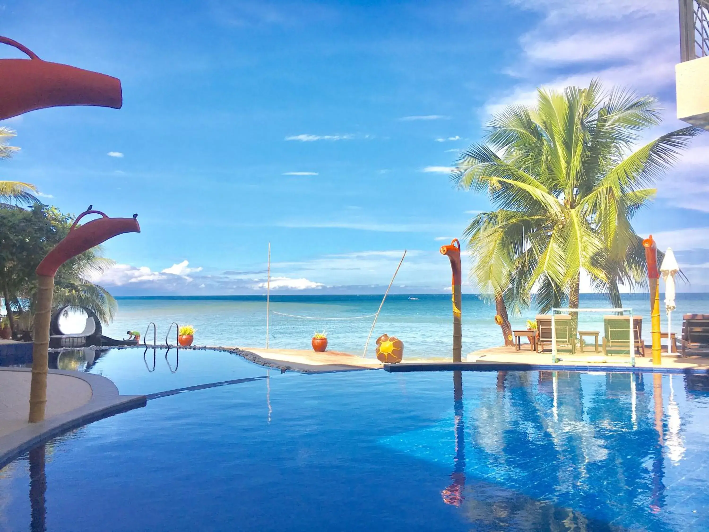 Swimming Pool in Sunset At Aninuan Beach Resort