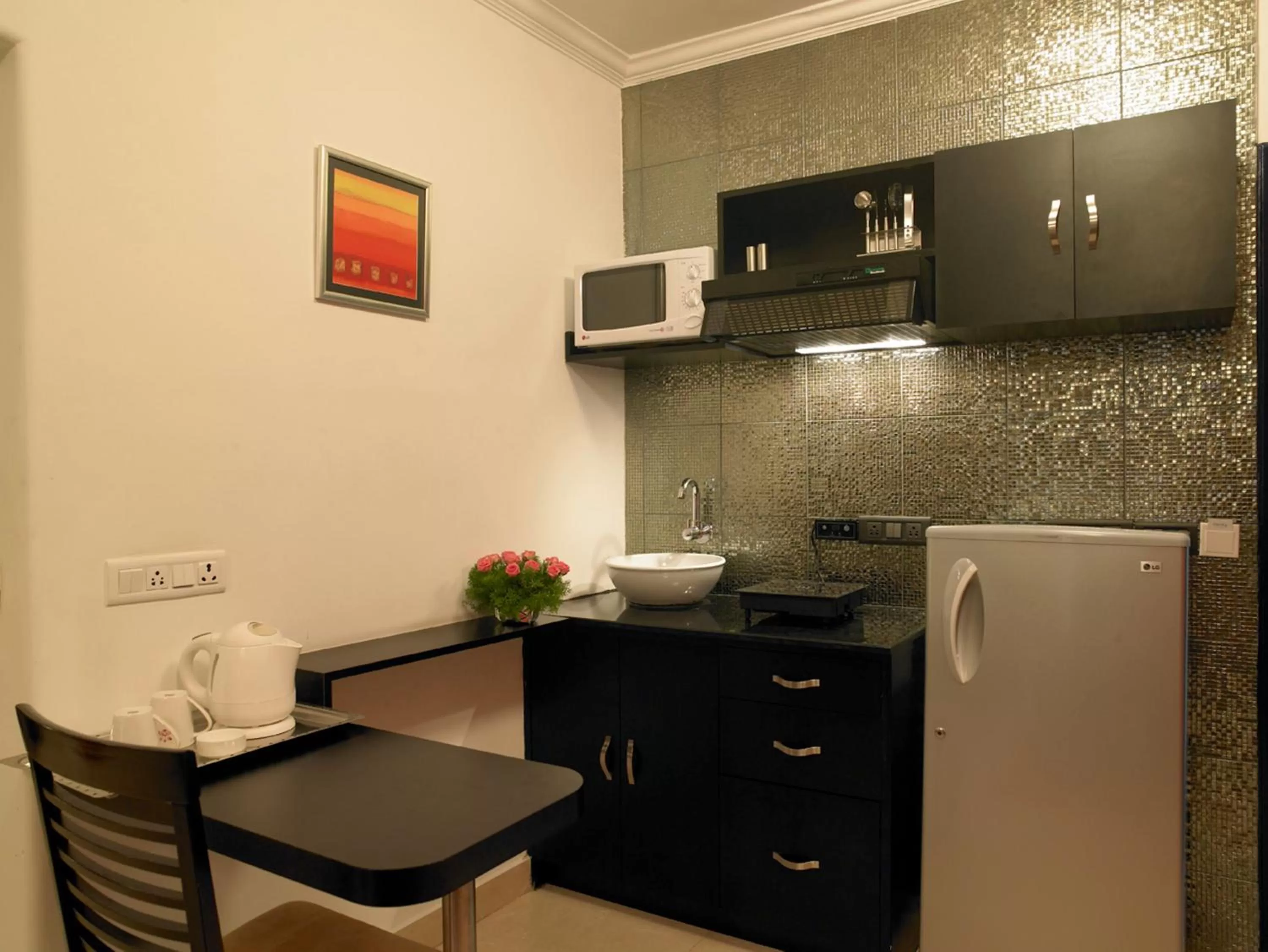 Kitchen or kitchenette in Royal Orchid Golden Suites Pune