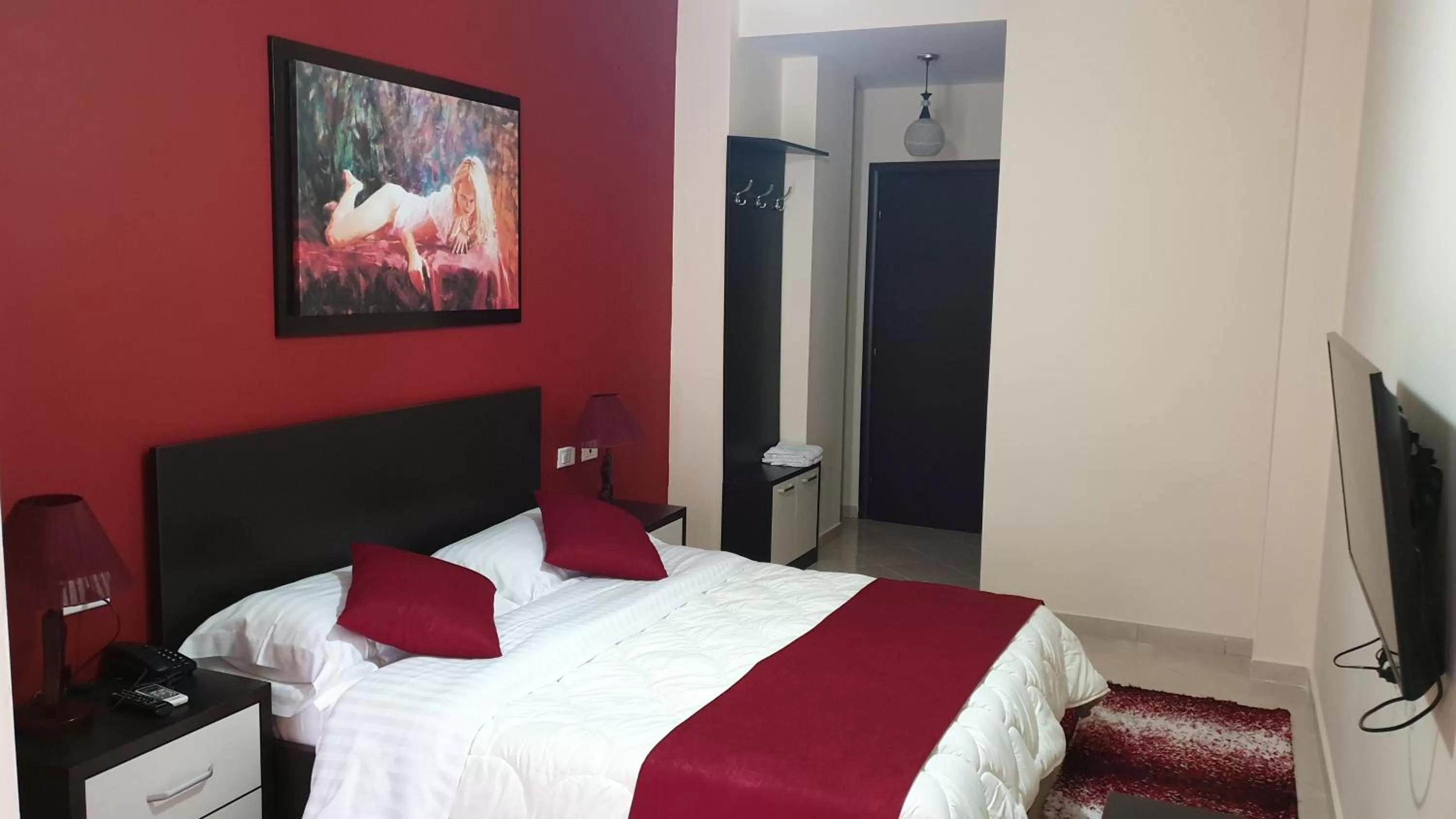 Communal lounge/ TV room, Bed in Haris Hotel