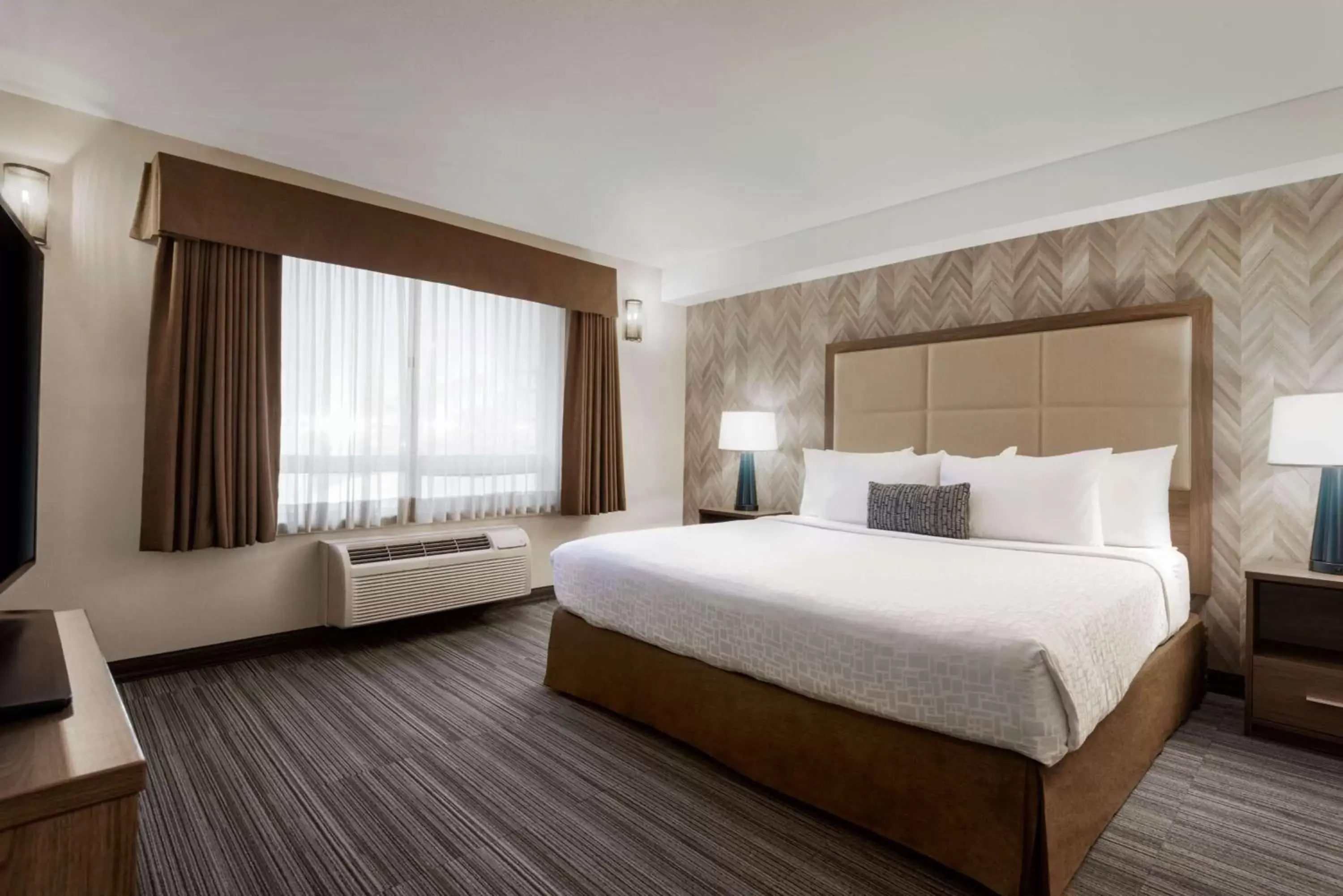 Photo of the whole room, Bed in Ramada by Wyndham Airdrie Hotel & Suites