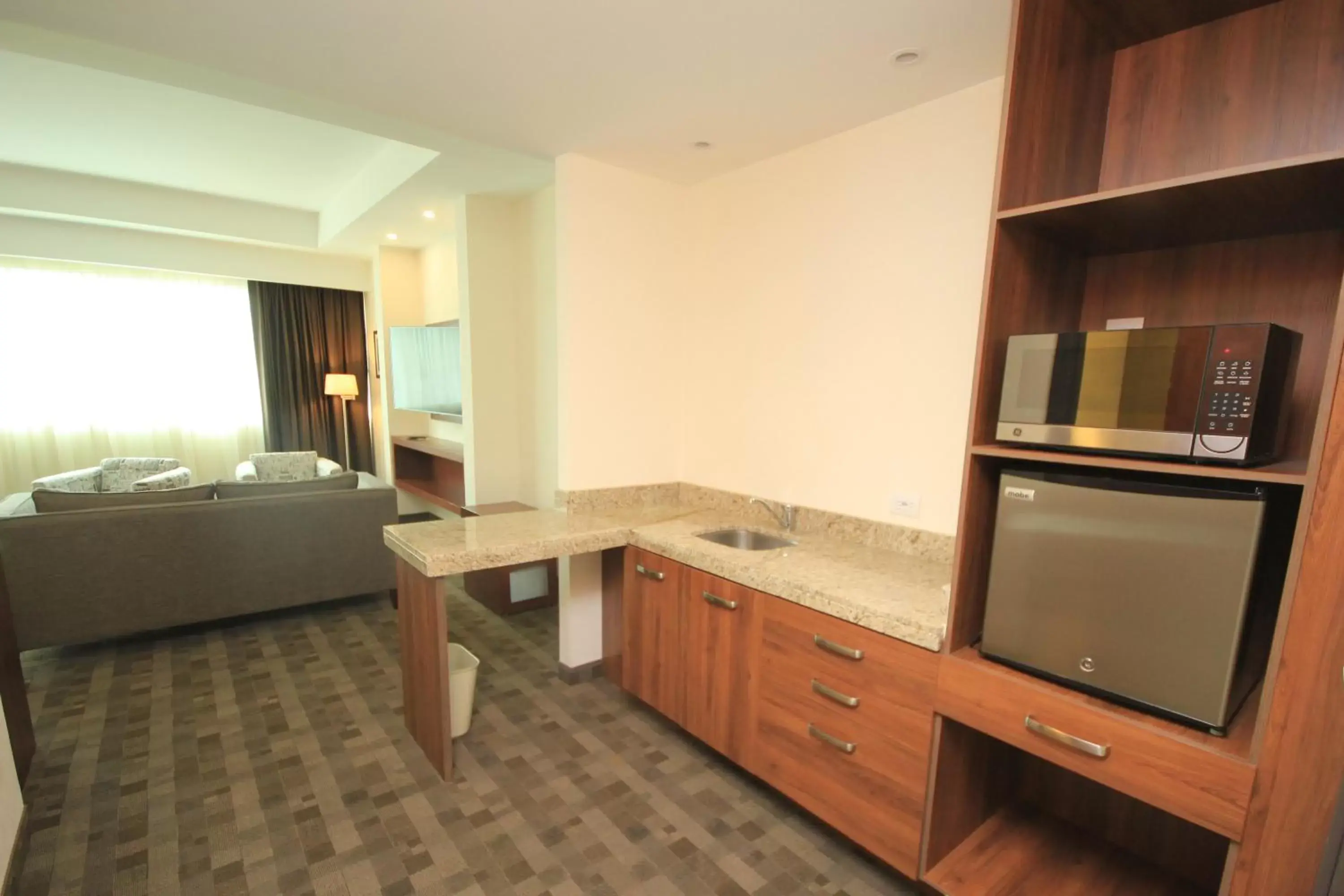 Photo of the whole room, Kitchen/Kitchenette in Holiday Inn & Suites Plaza Mayor, an IHG Hotel