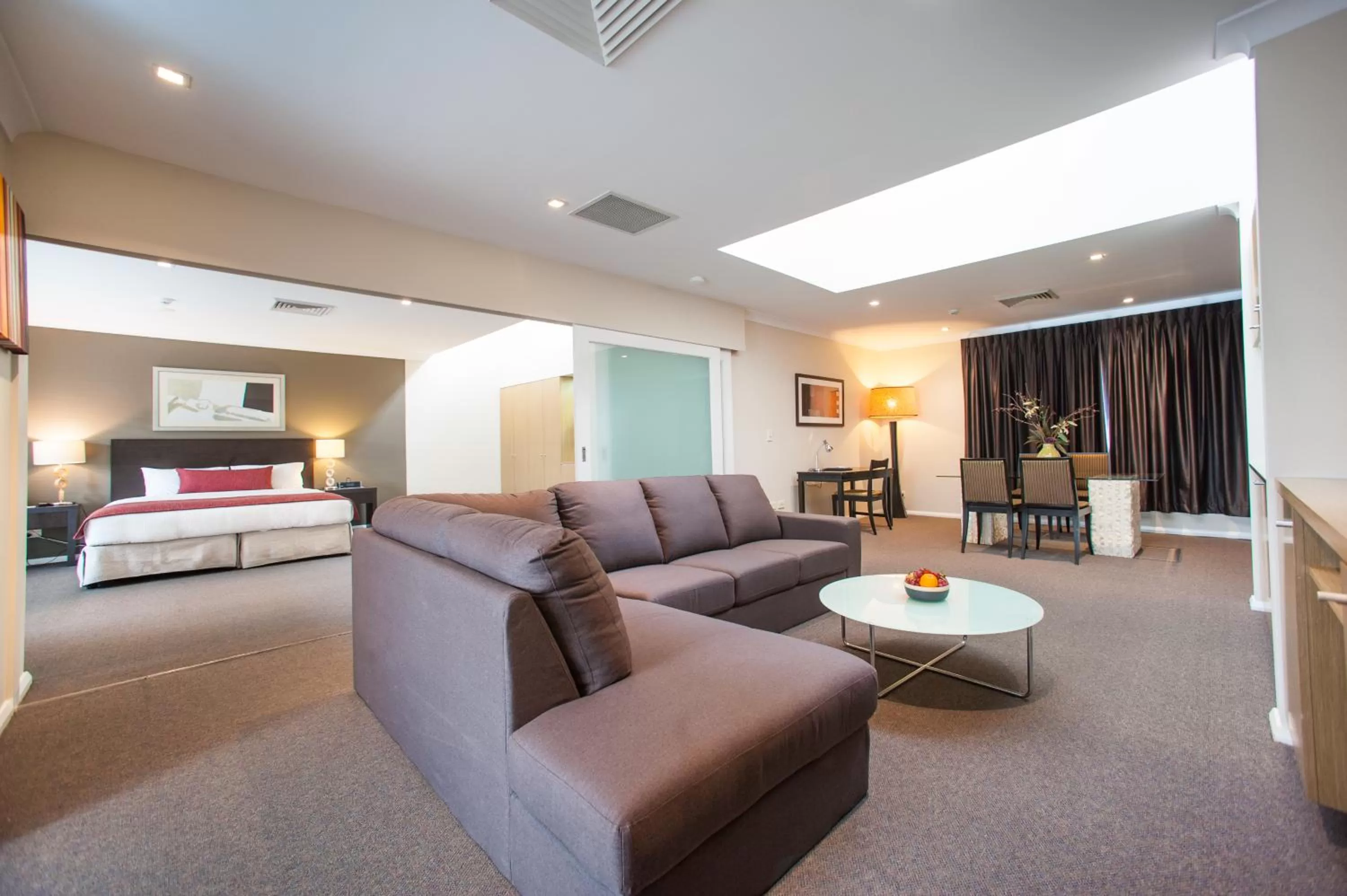 Living room, Bed in Ramada Hotel & Suites by Wyndham Cabramatta