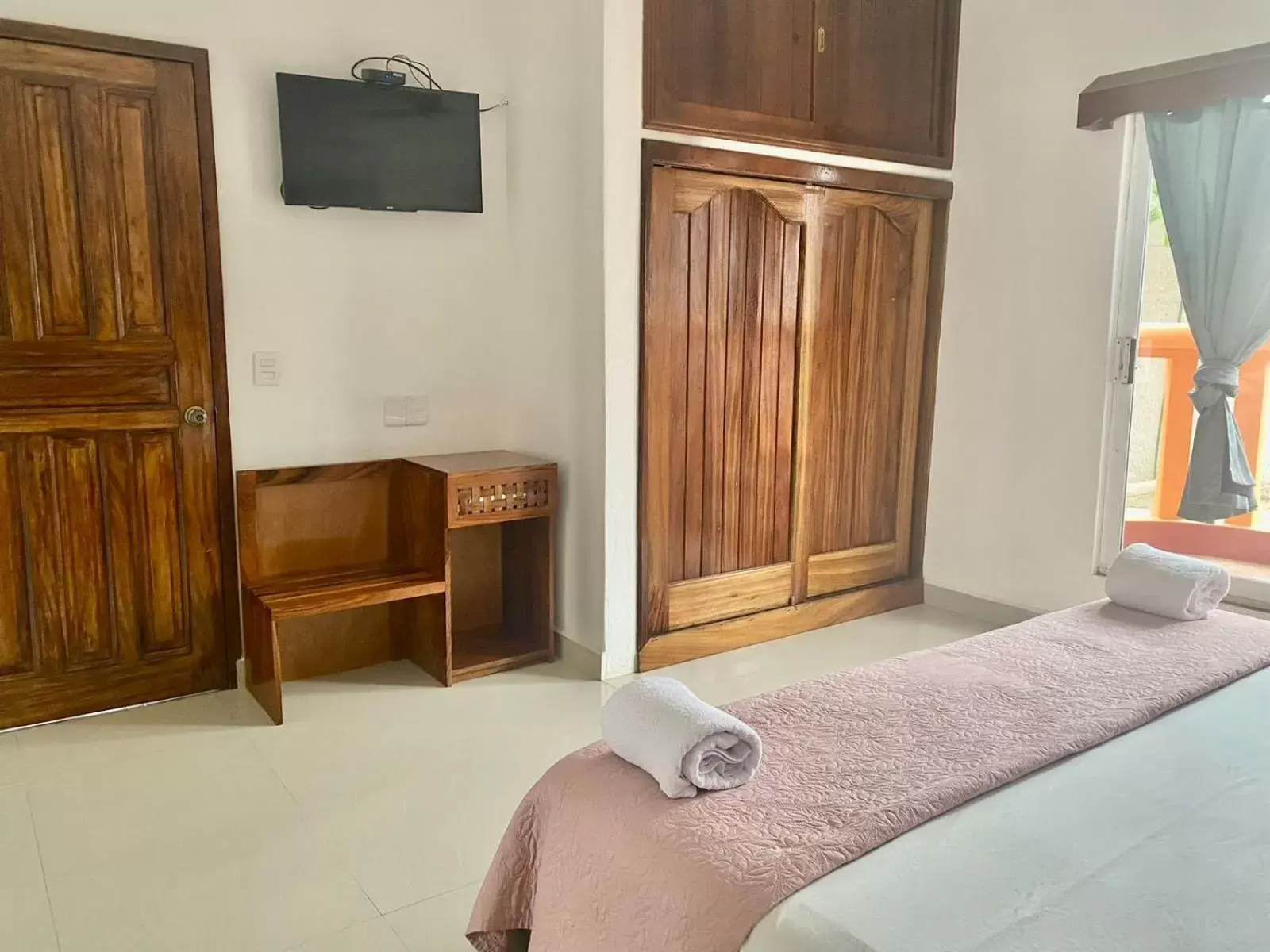 Bed, TV/Entertainment Center in Suites Ximajo