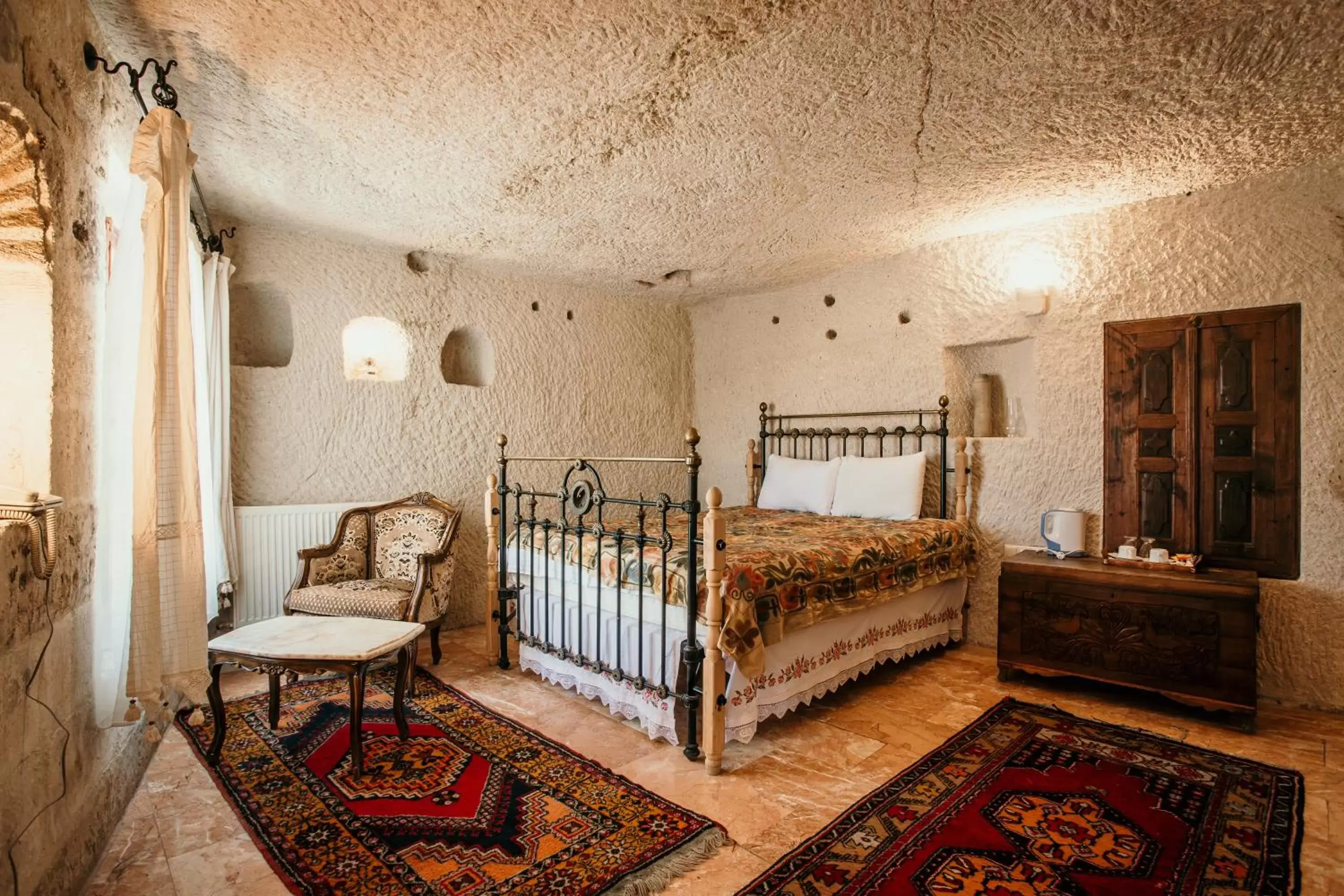 Bed, Seating Area in Village Cave House Hotel