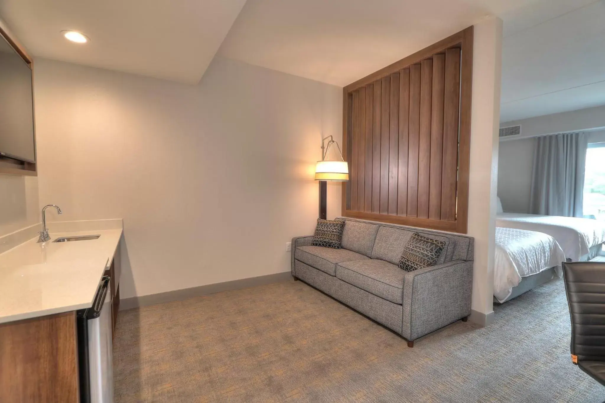 Bedroom, Seating Area in Holiday Inn & Suites Pigeon Forge Convention Center, an IHG Hotel