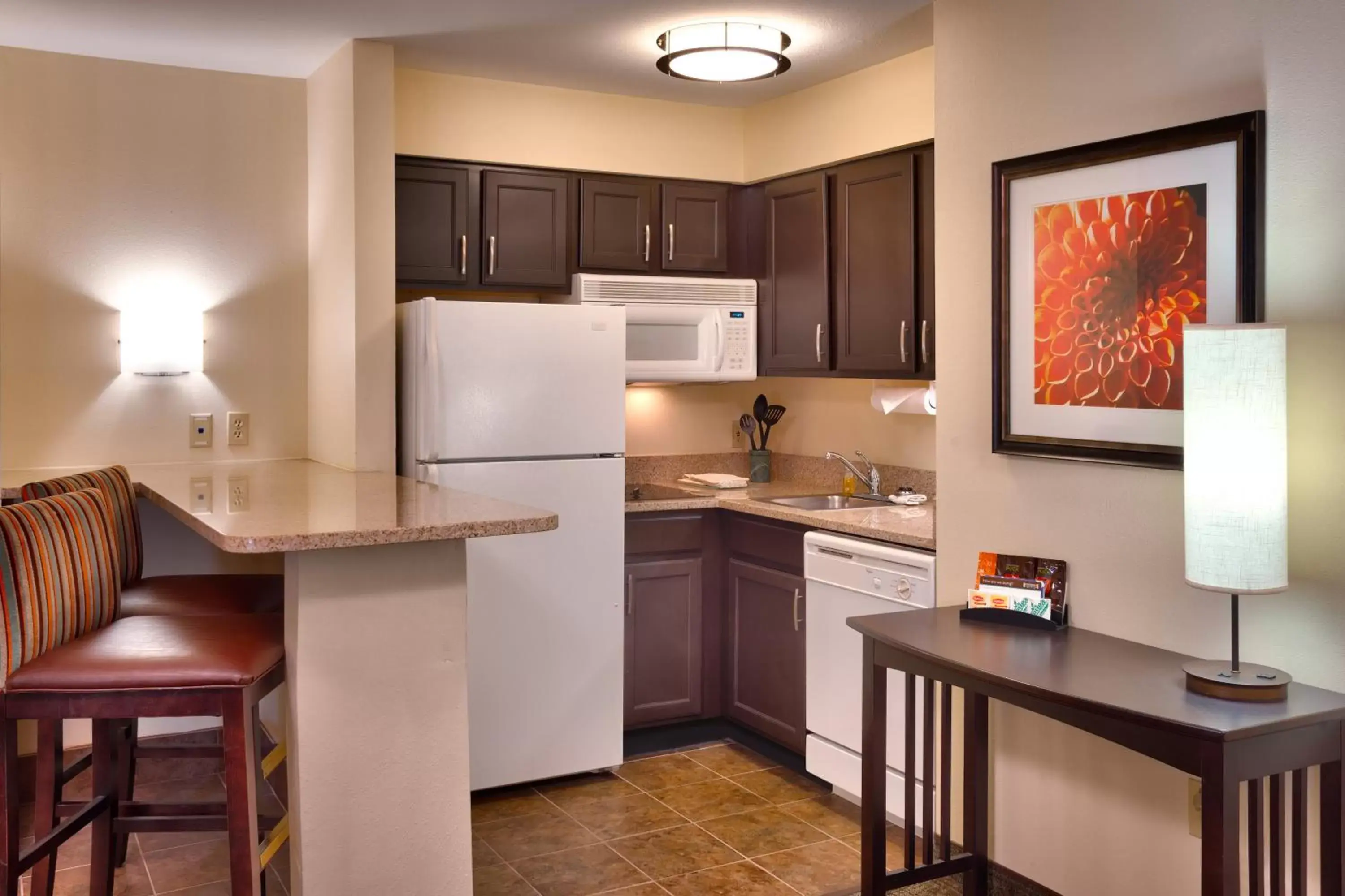 Bedroom, Kitchen/Kitchenette in Staybridge Suites Peoria Downtown, an IHG Hotel