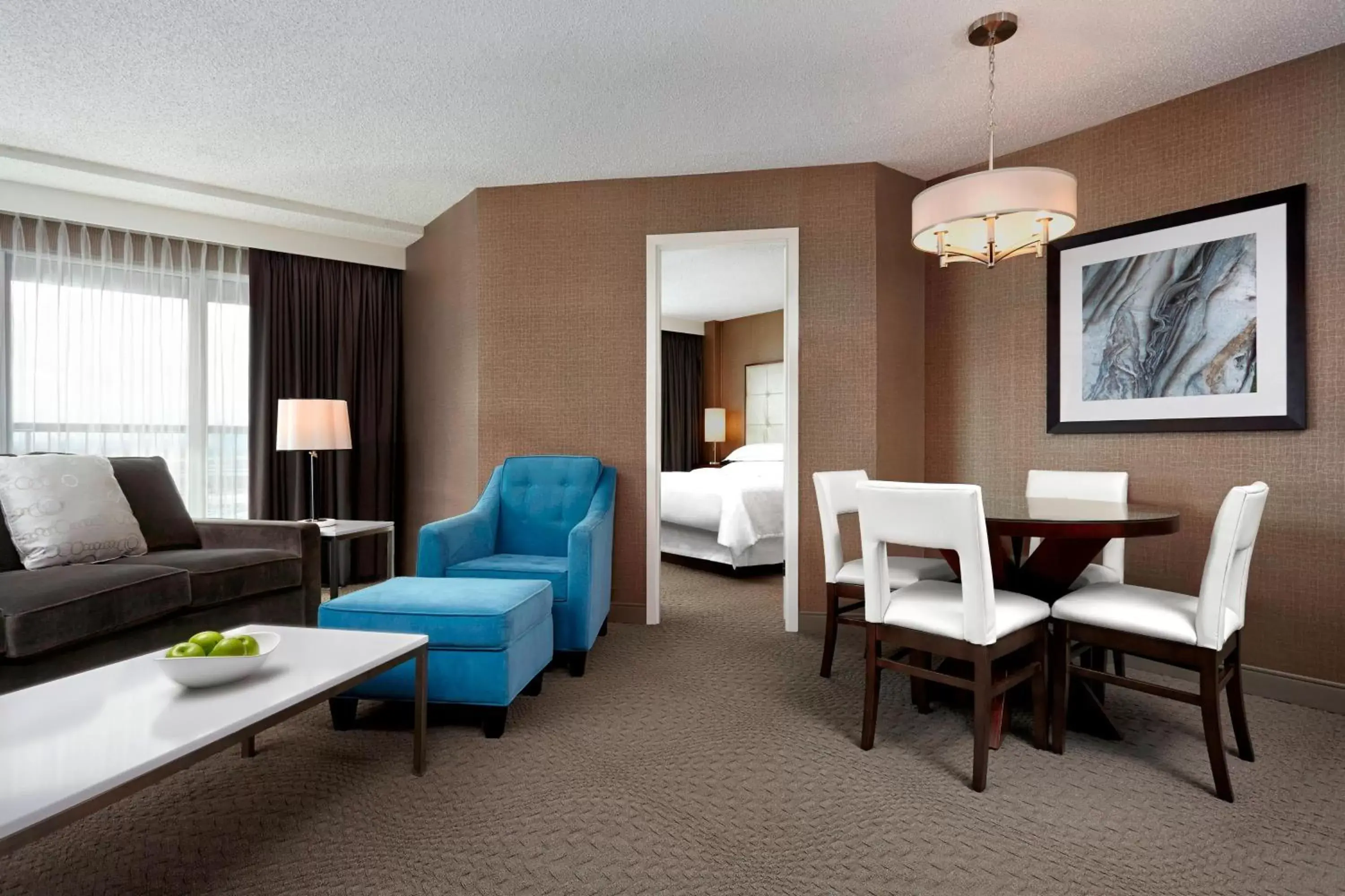 Bedroom, Seating Area in Sheraton Cavalier Calgary Hotel