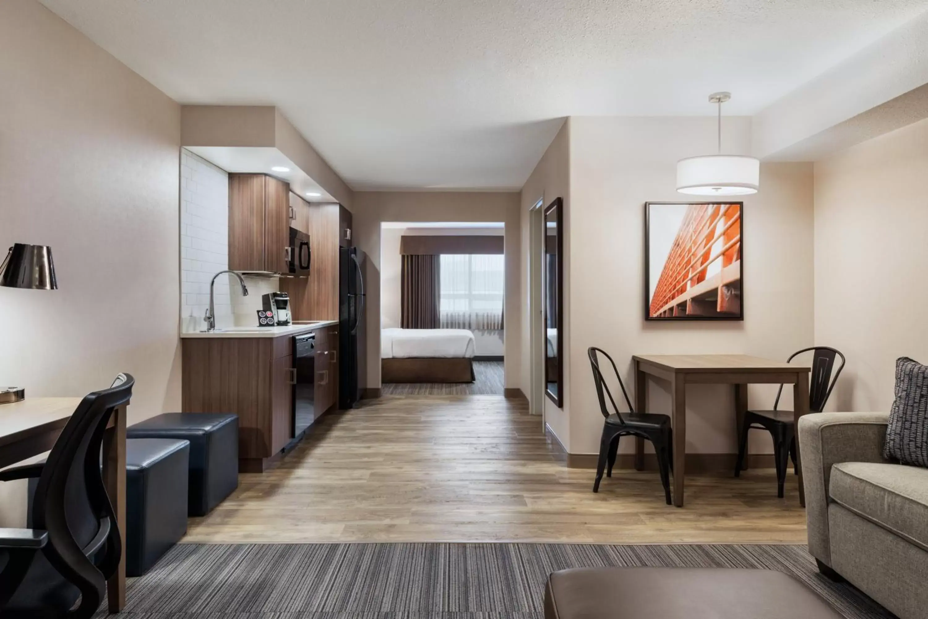 Living room, Seating Area in Ramada by Wyndham Airdrie Hotel & Suites