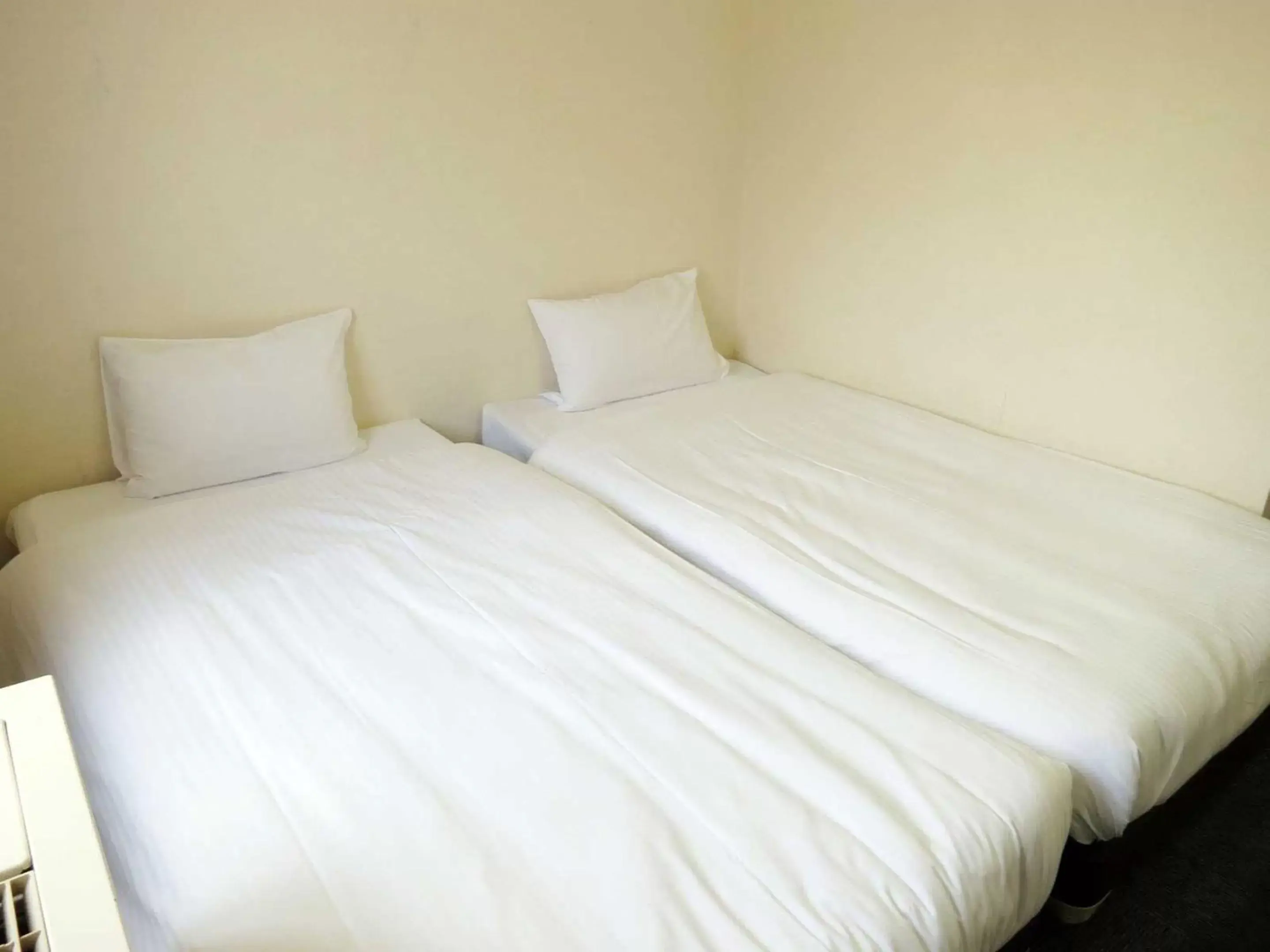 Bed in Heiwadai Hotel Arato
