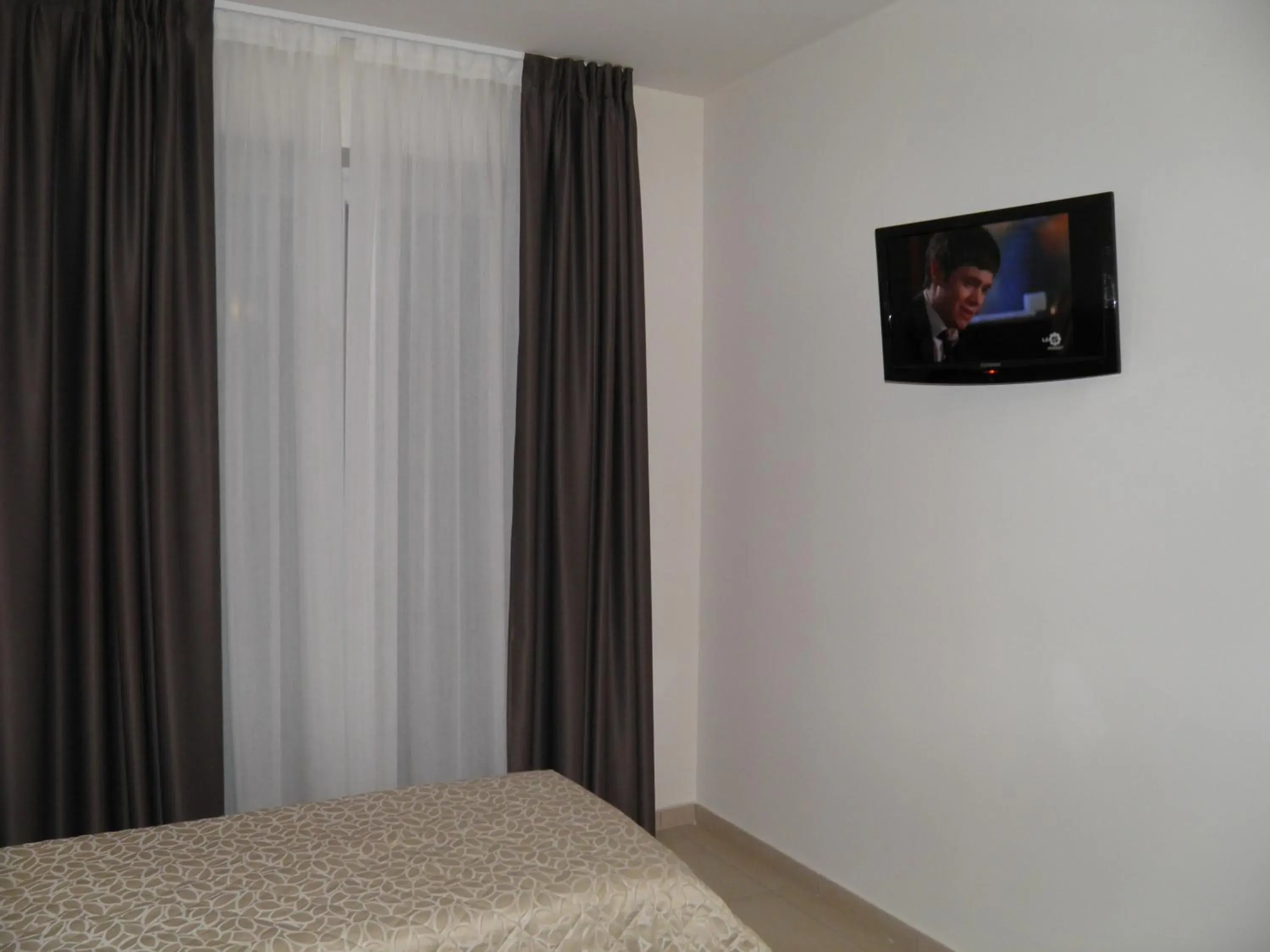 Bed, TV/Entertainment Center in Hotel I Crespi
