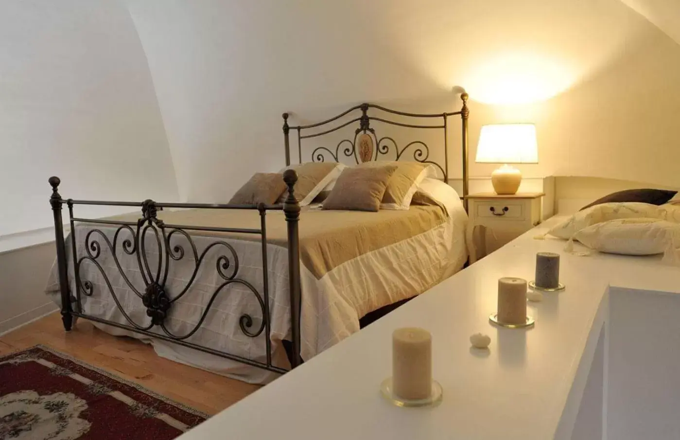 Bed in ARCOBELLO Suite Rooms