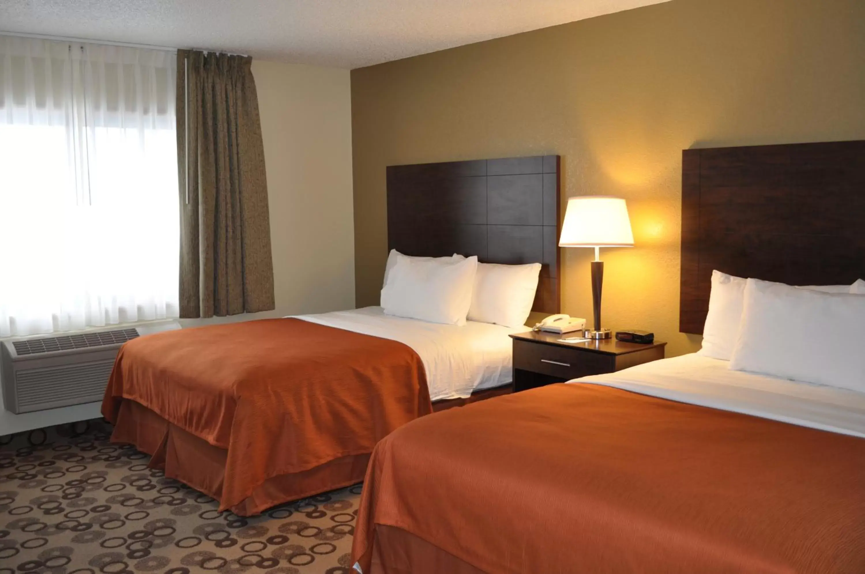 Bed in AmericInn by Wyndham Cedar Falls