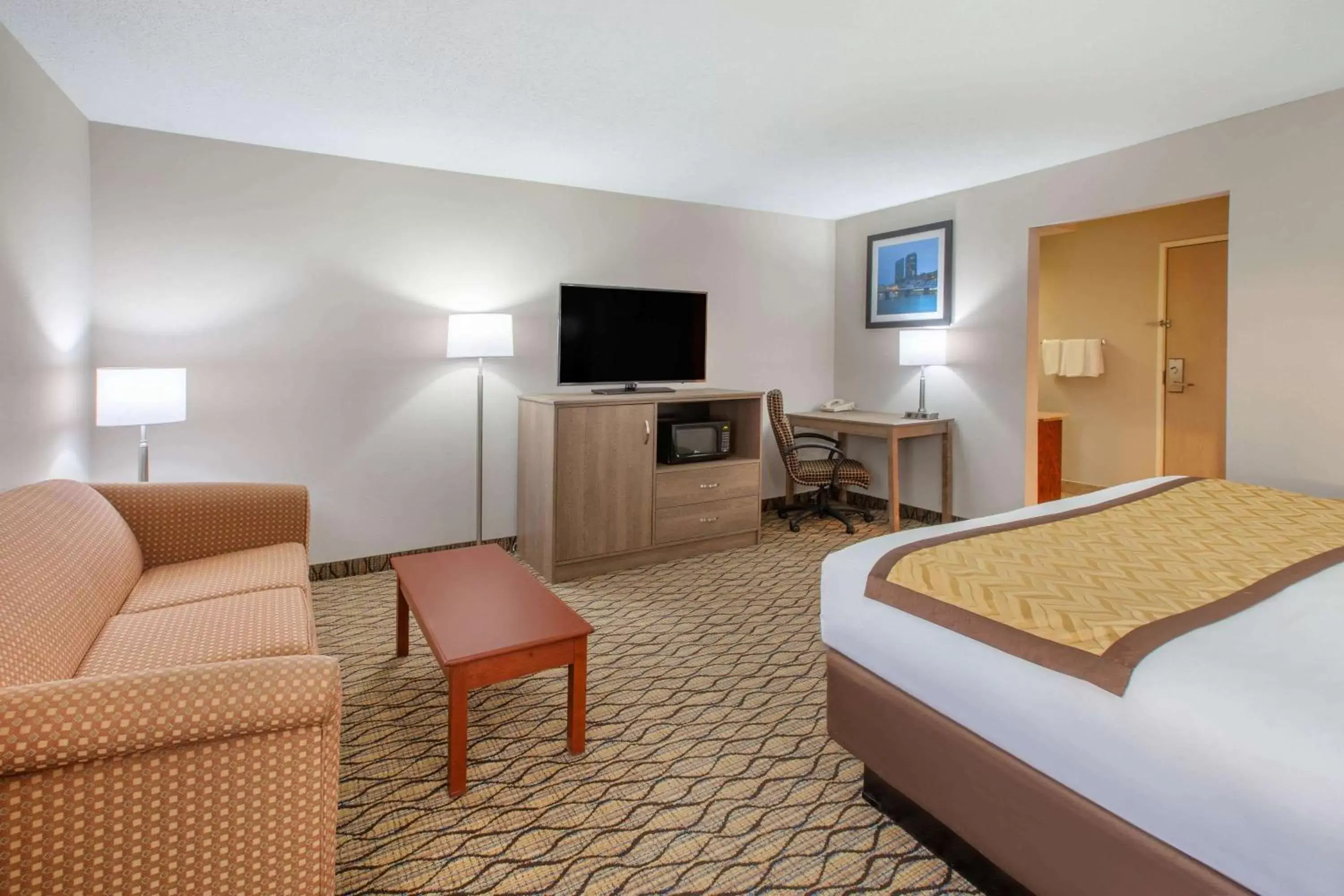 Photo of the whole room, TV/Entertainment Center in Baymont by Wyndham Grand Rapids Airport