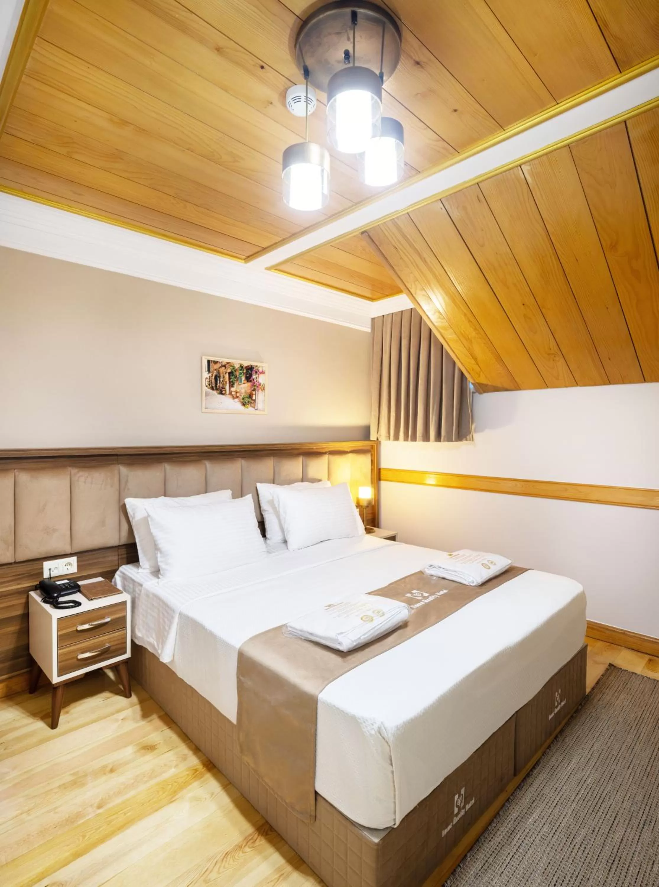 Bed in HOME QUALITY HOTEL