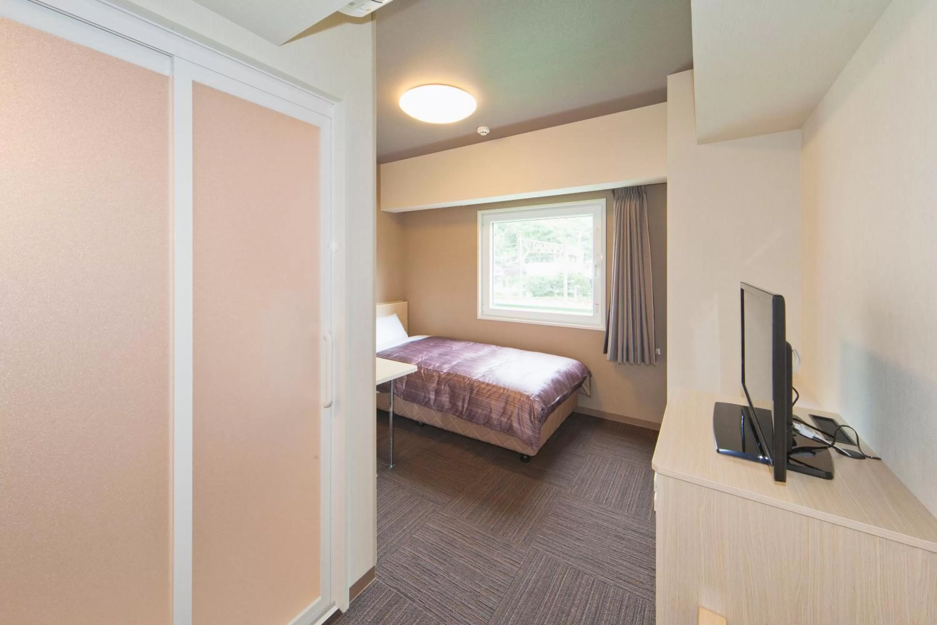 Photo of the whole room, Bed in Hotel Route-Inn Saiki Ekimae