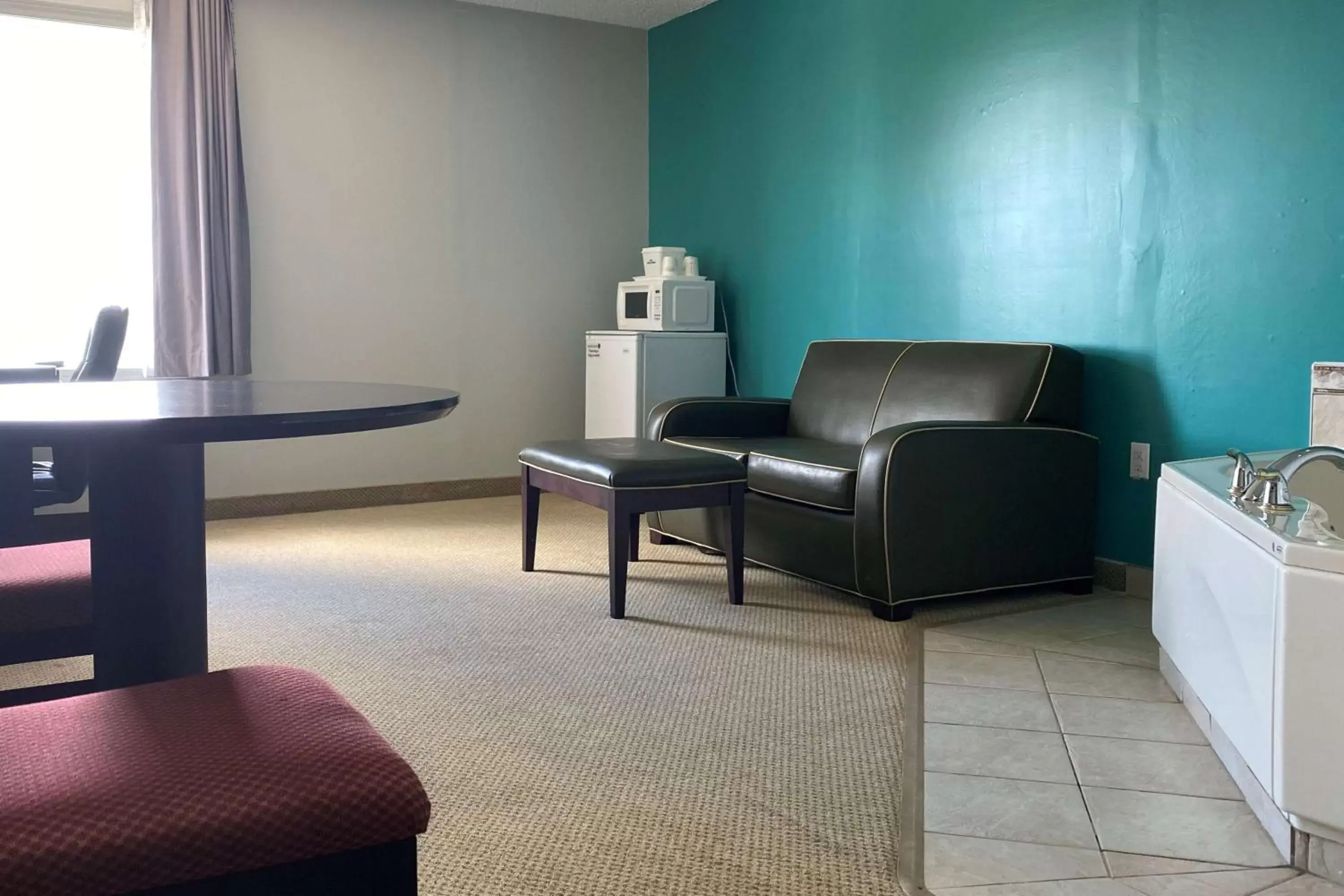 Photo of the whole room, Seating Area in Travelodge by Wyndham Miramichi New Brunswick