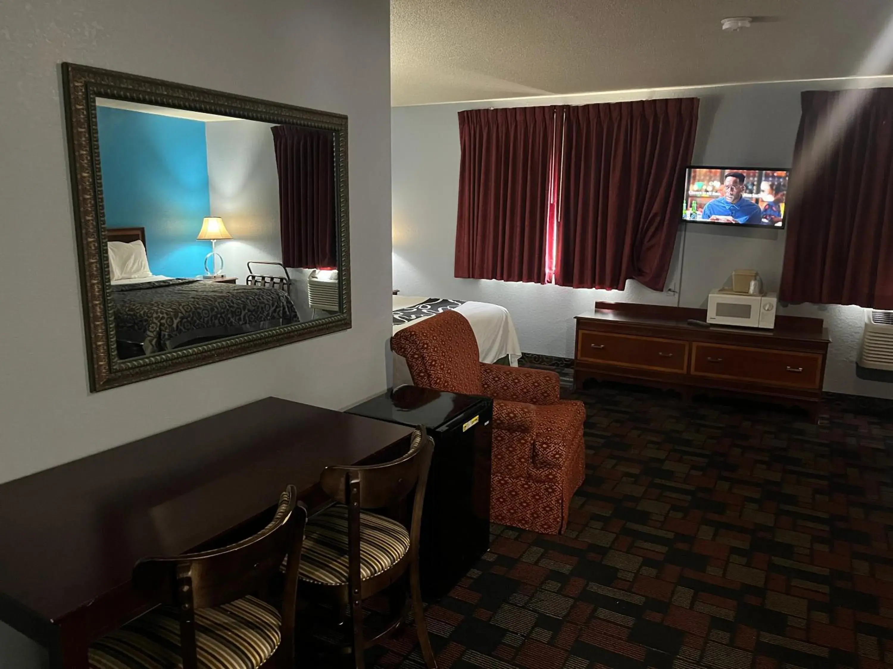 Photo of the whole room, TV/Entertainment Center in Rodeway Inn
