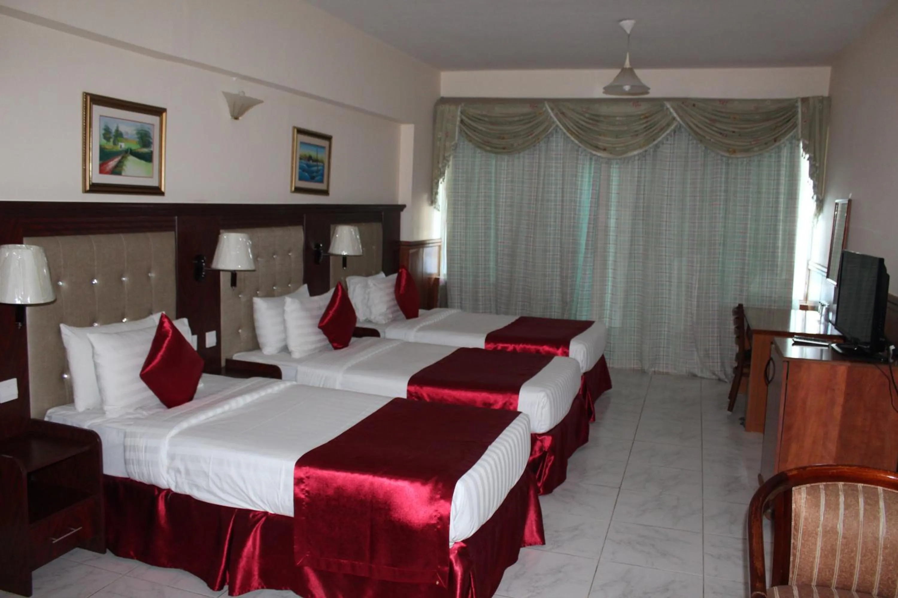 Bed in Grand Nova Hotel