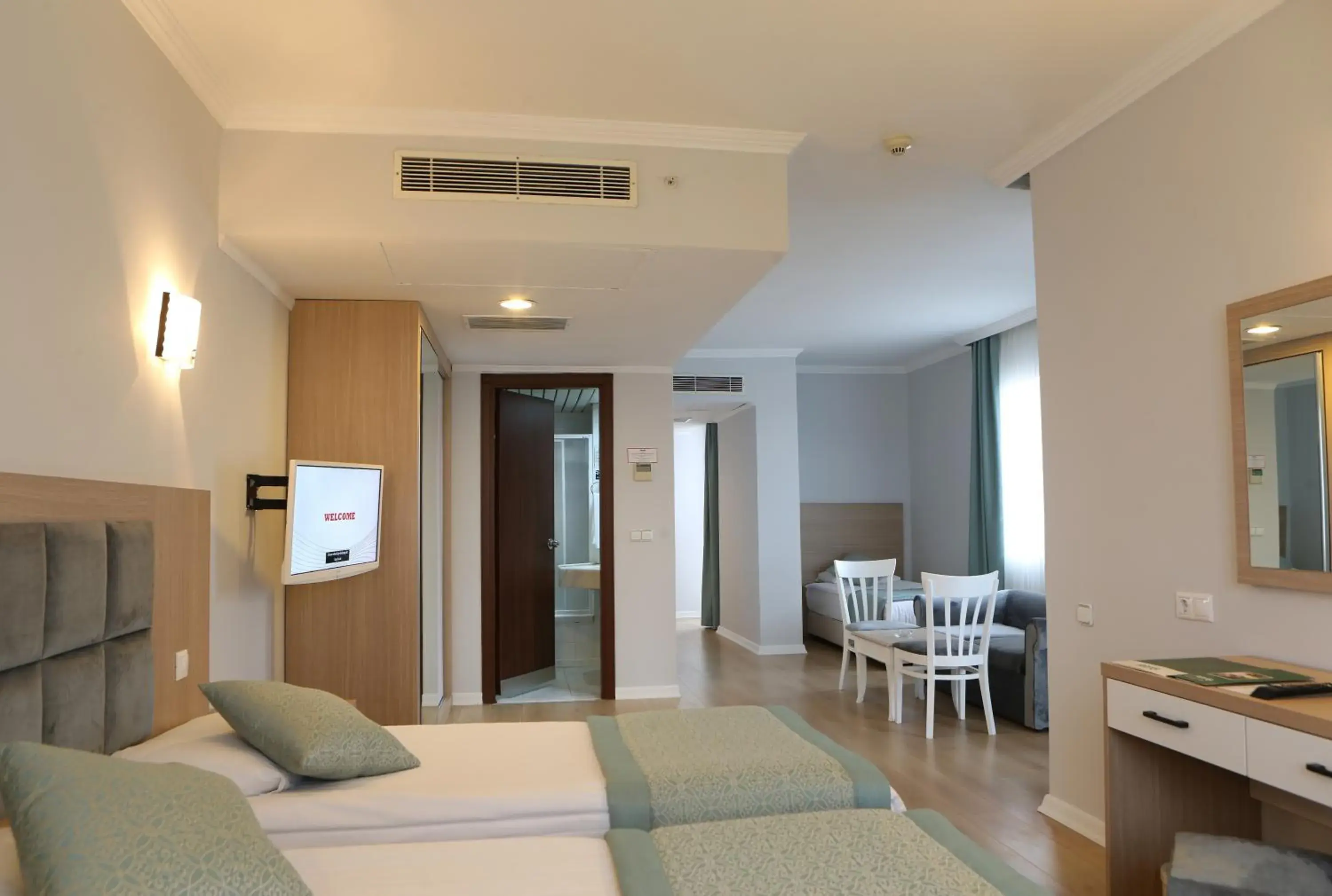 Bed, TV/Entertainment Center in Adonis Hotel