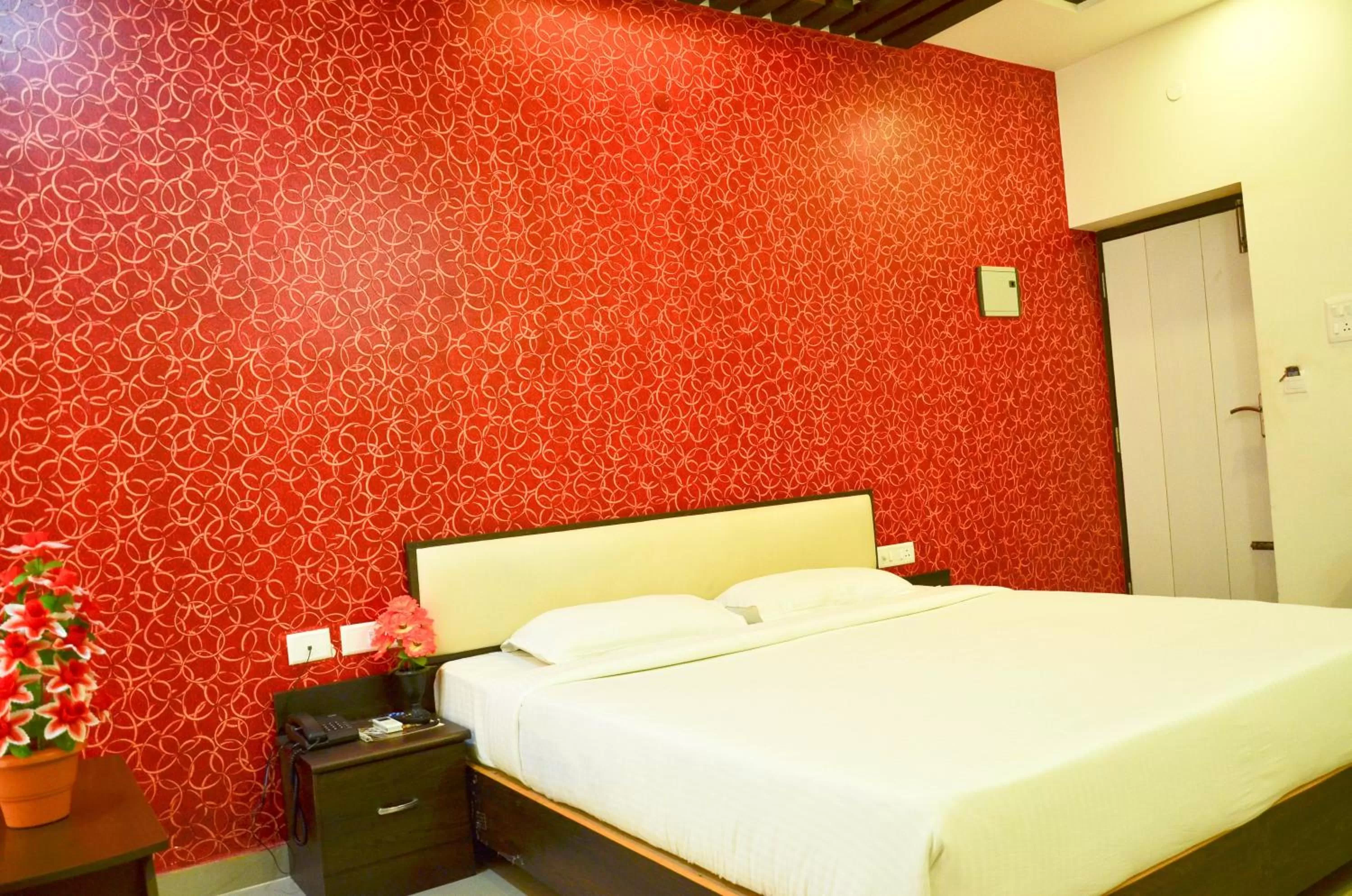 Bed in Hotel Ambai Grand