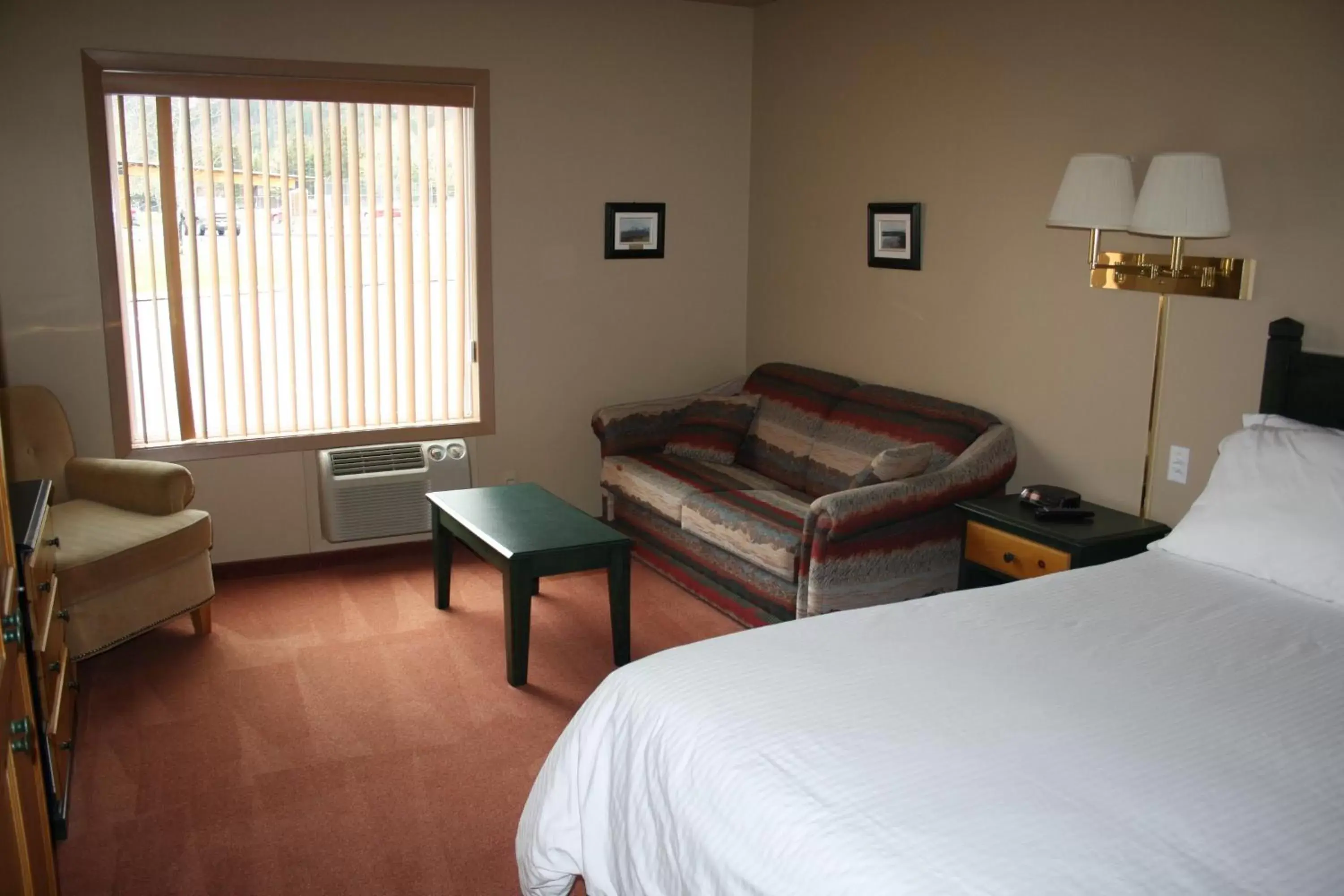 Bed, Seating Area in Waterton Lakes Lodge Resort