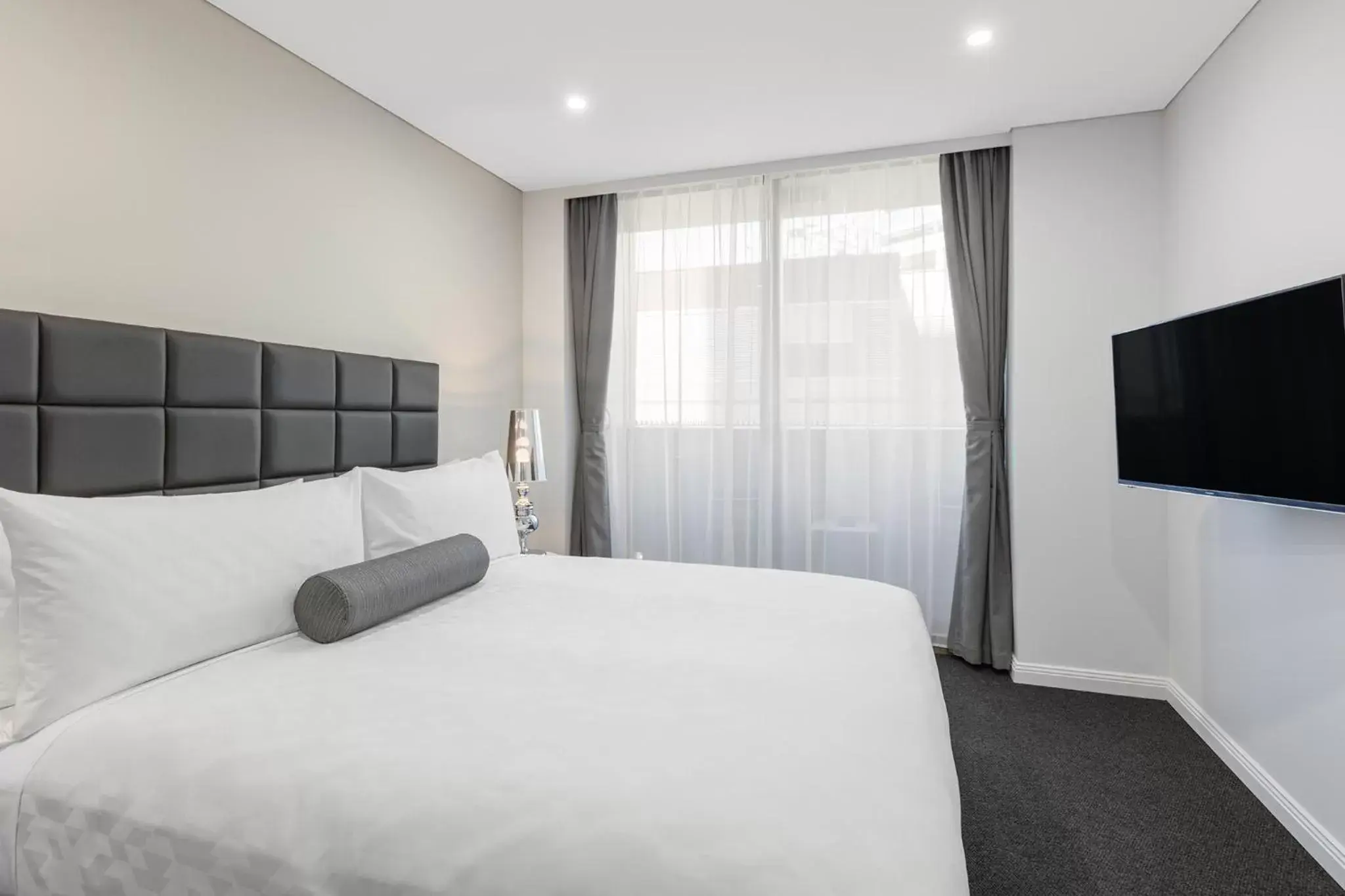 Bed in Meriton Suites North Sydney