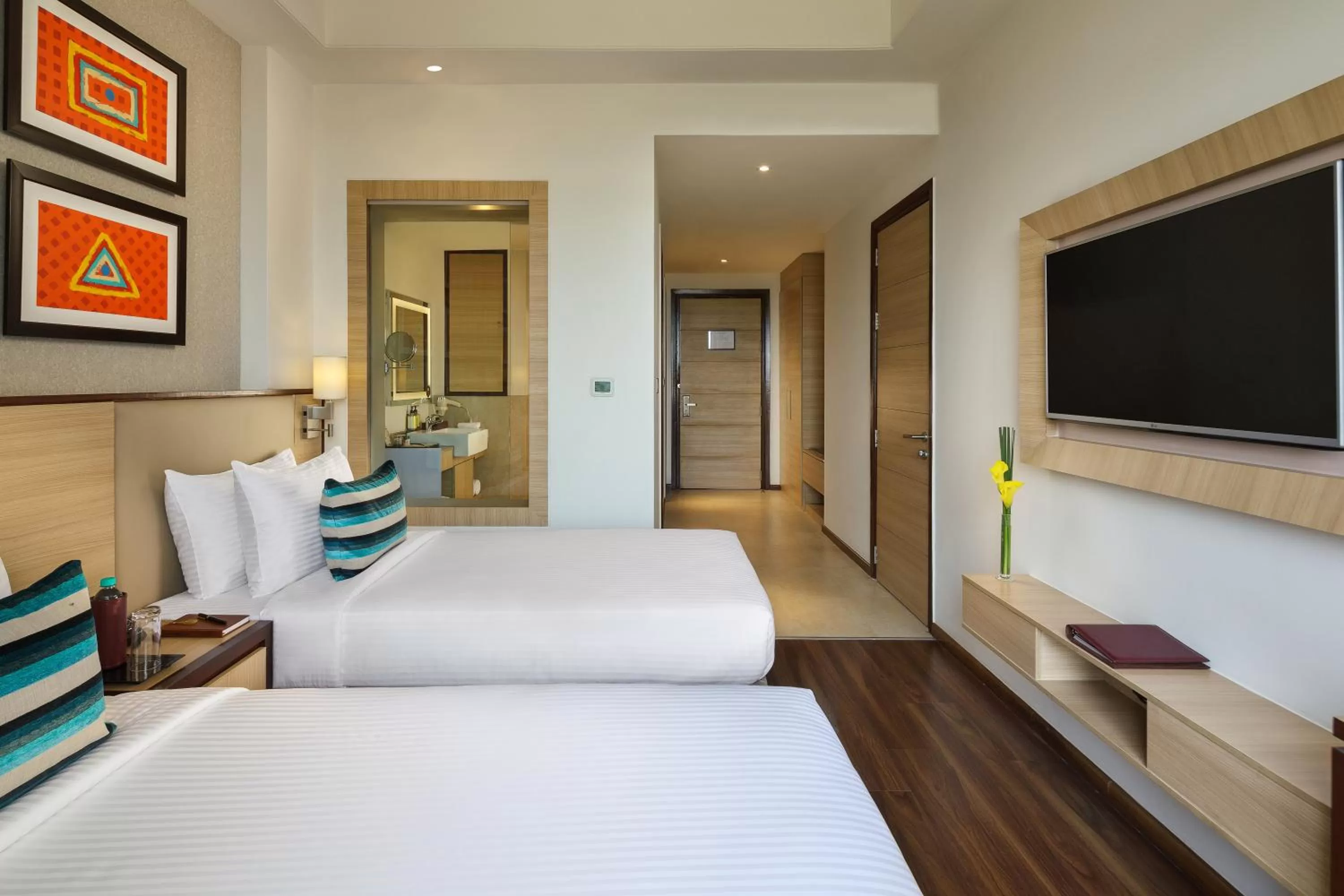 Bed in Sandal Suites by Lemon Tree Hotels