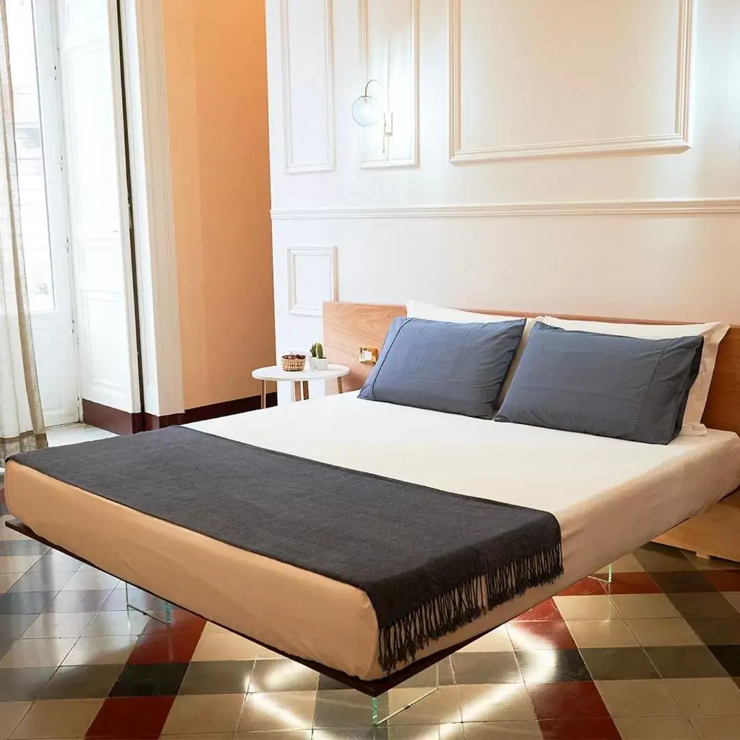 Bed in Toscano Palace Luxury Rooms Catania