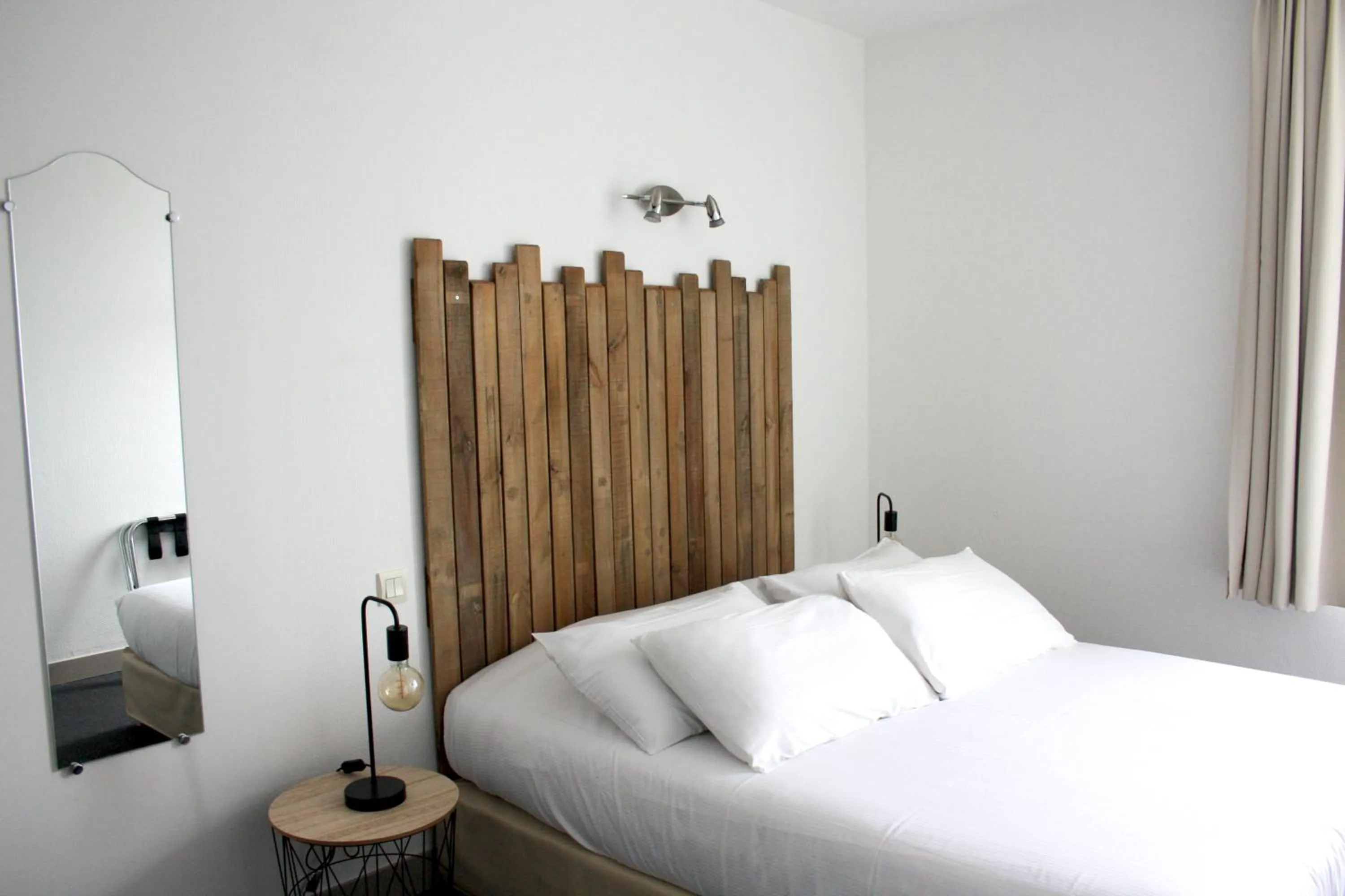 Bed in Logis Hôtel Sea View