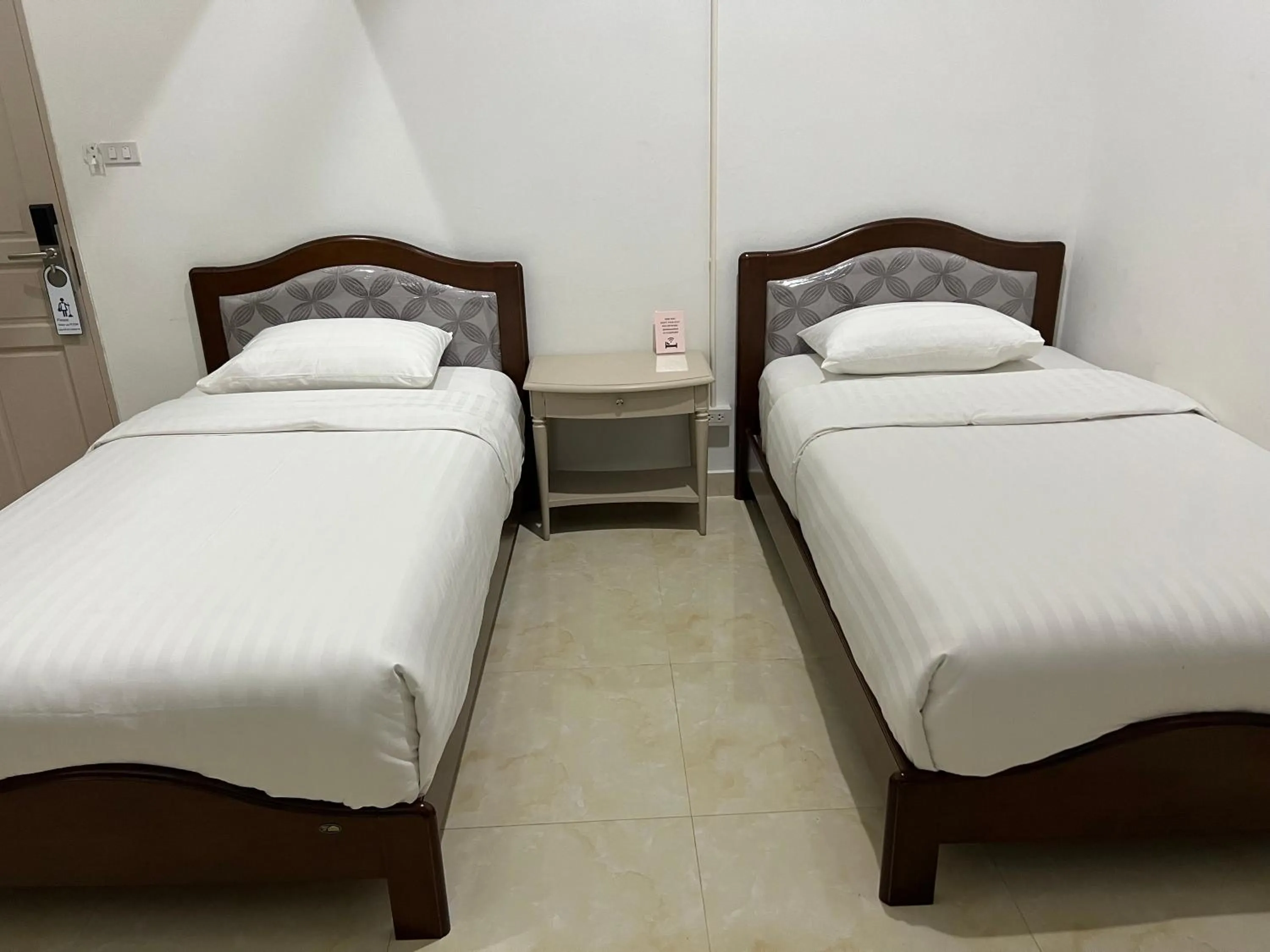 Bed in Mall Suites Hotel