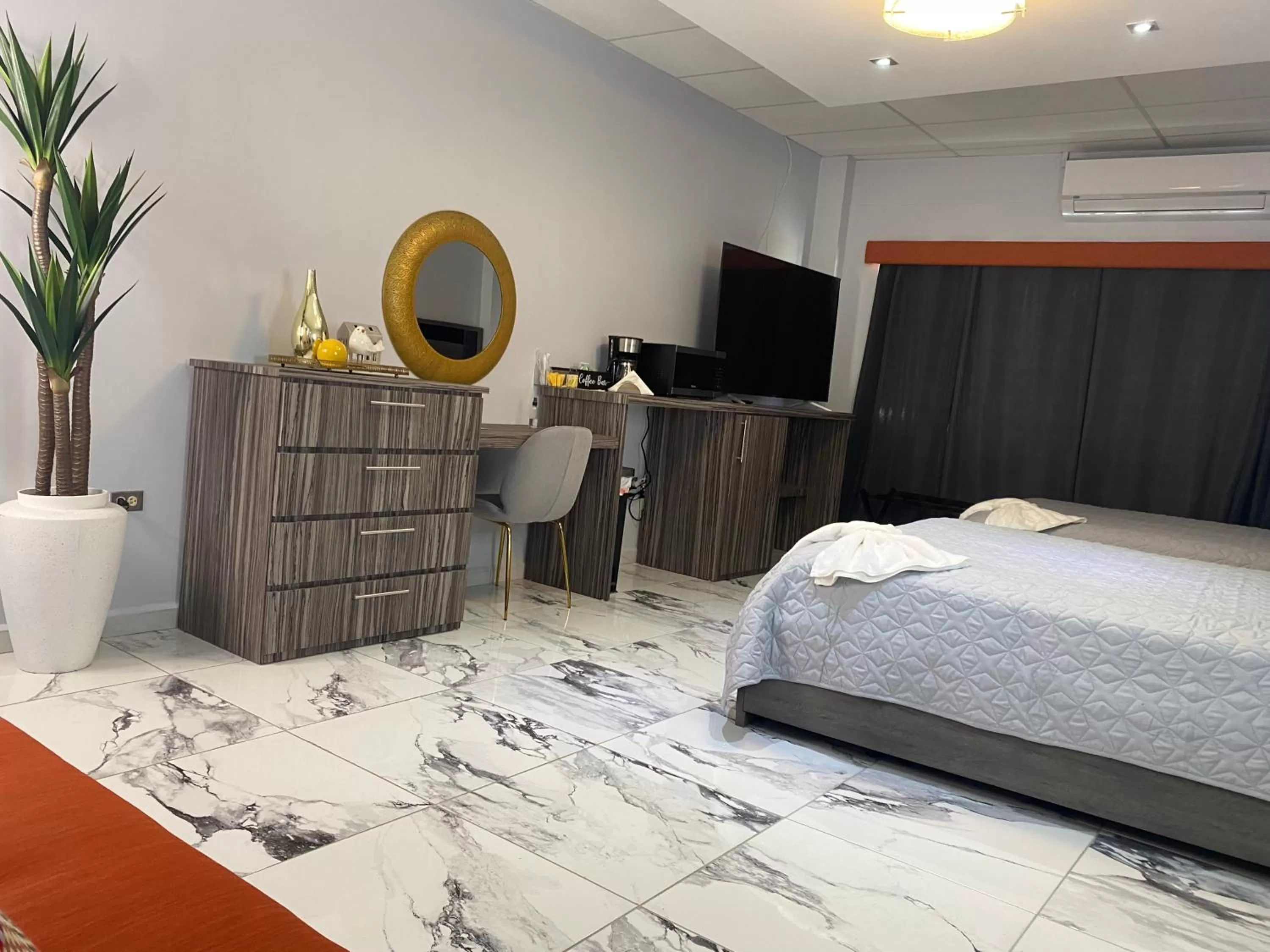 Bed in Itza-Bella Suites