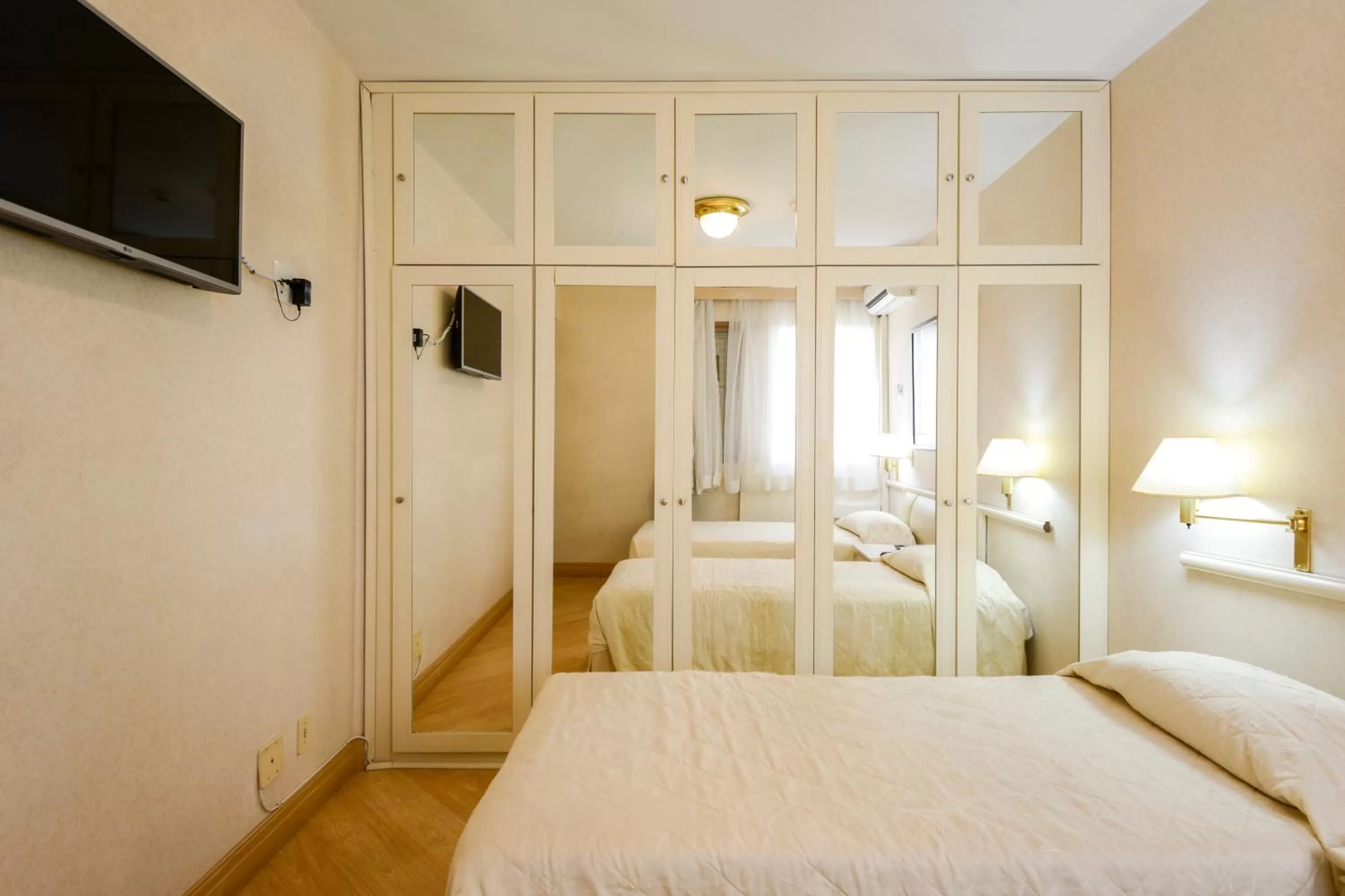 Bed in Wall Street Apartments by BnbHost
