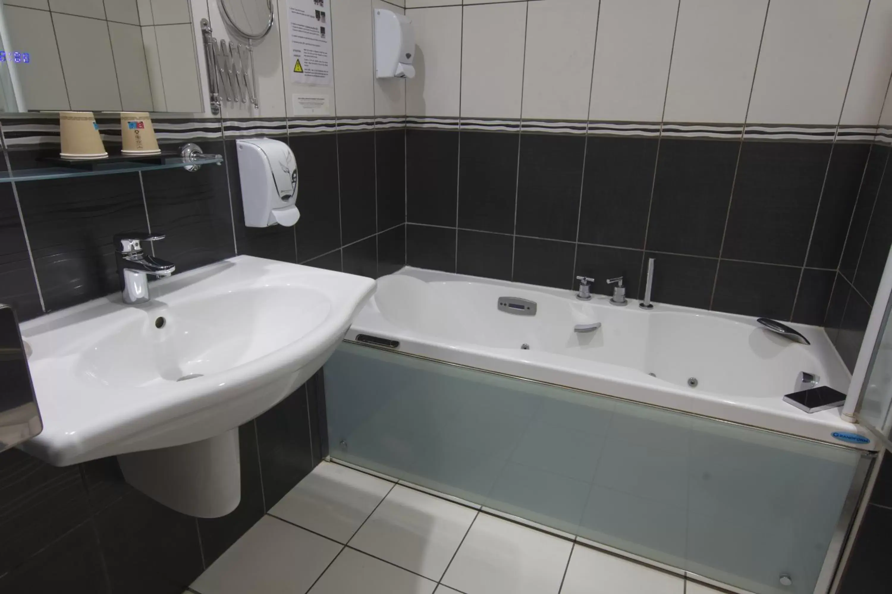 Bathroom in Logis Centrotel et Spa Bulles d'Allier