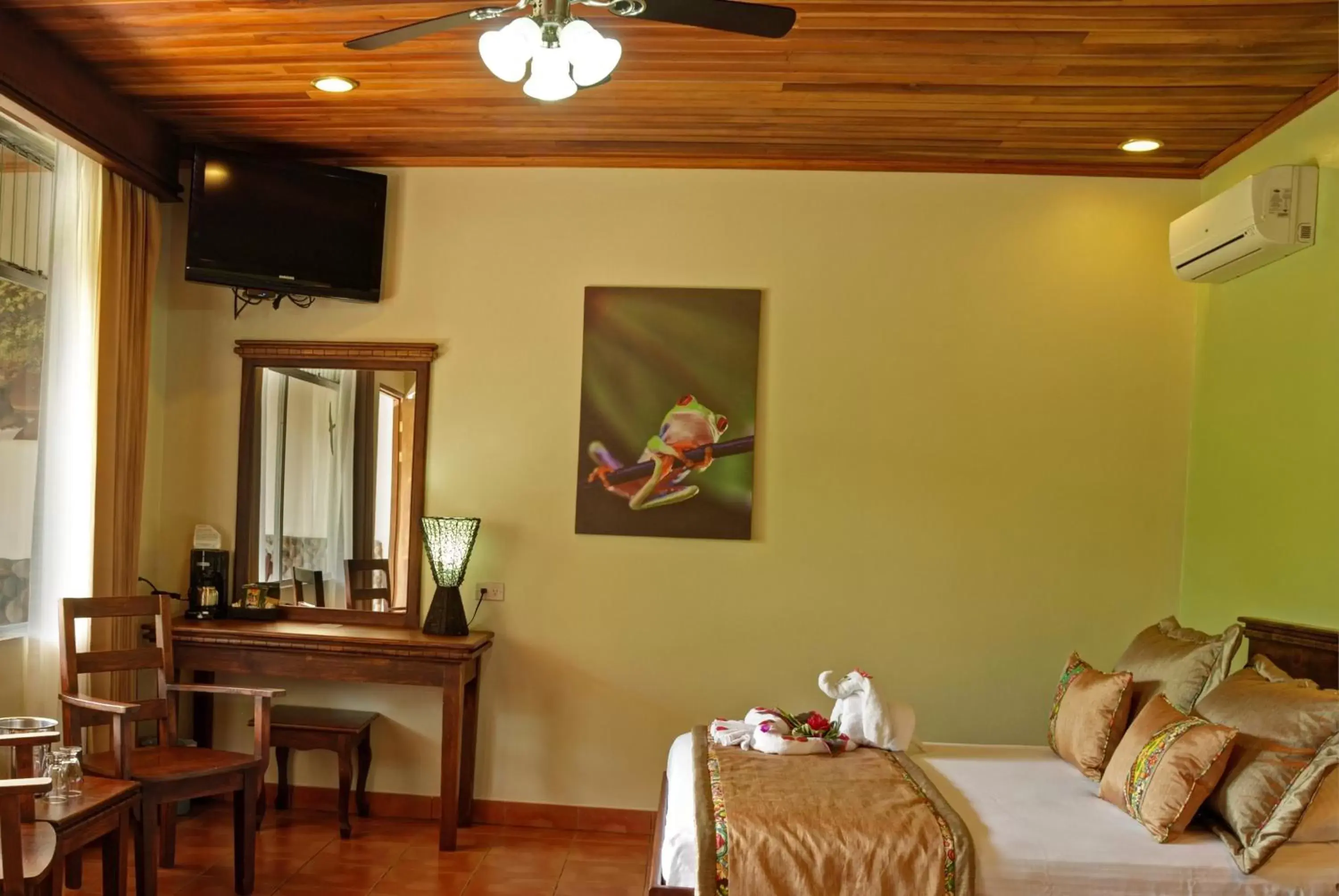 Bed, TV/Entertainment Center in Volcano Lodge, Hotel & Thermal Experience