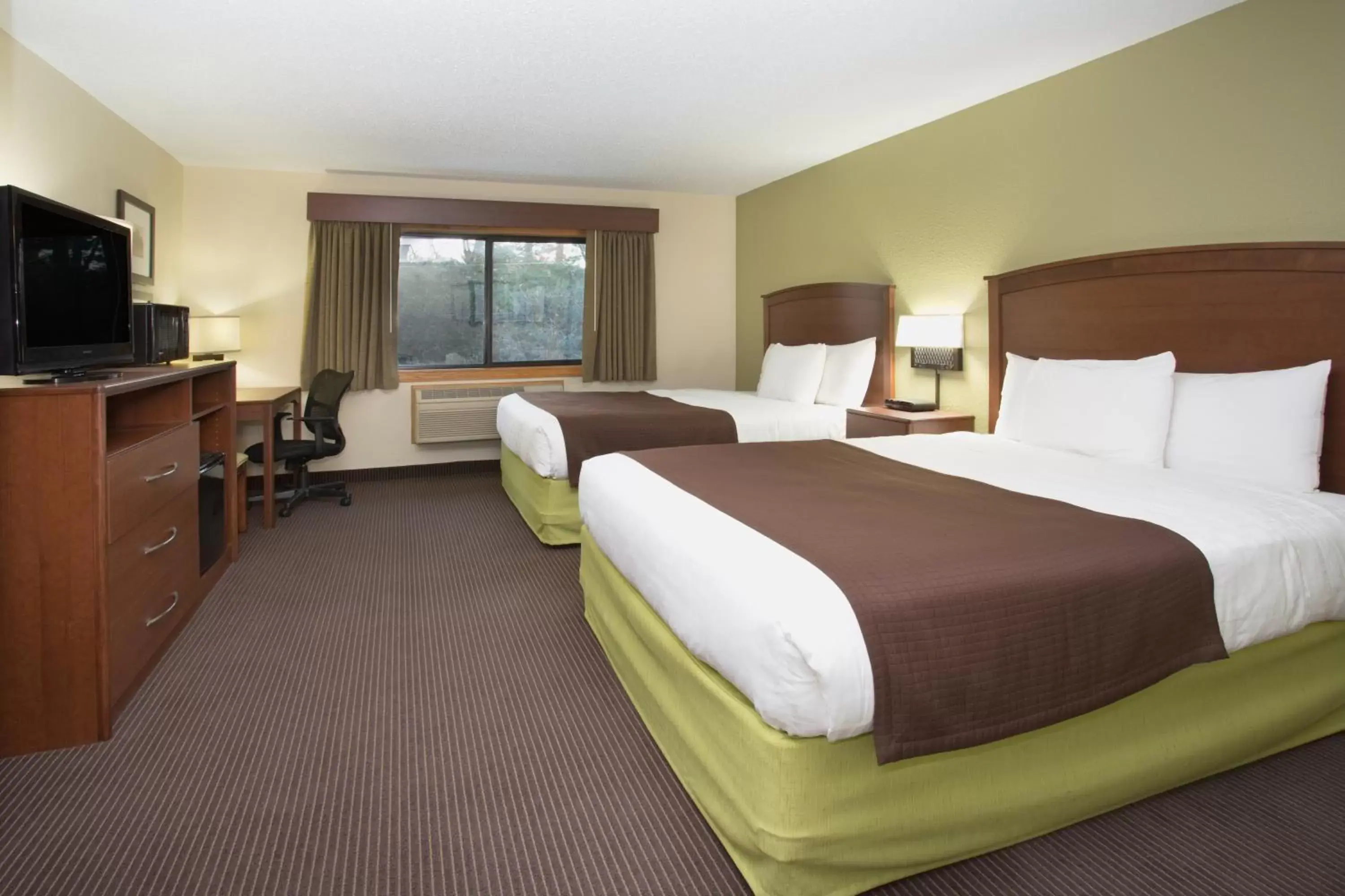 Bed in Cobblestone Hotel & Suites - Wisconsin Rapids