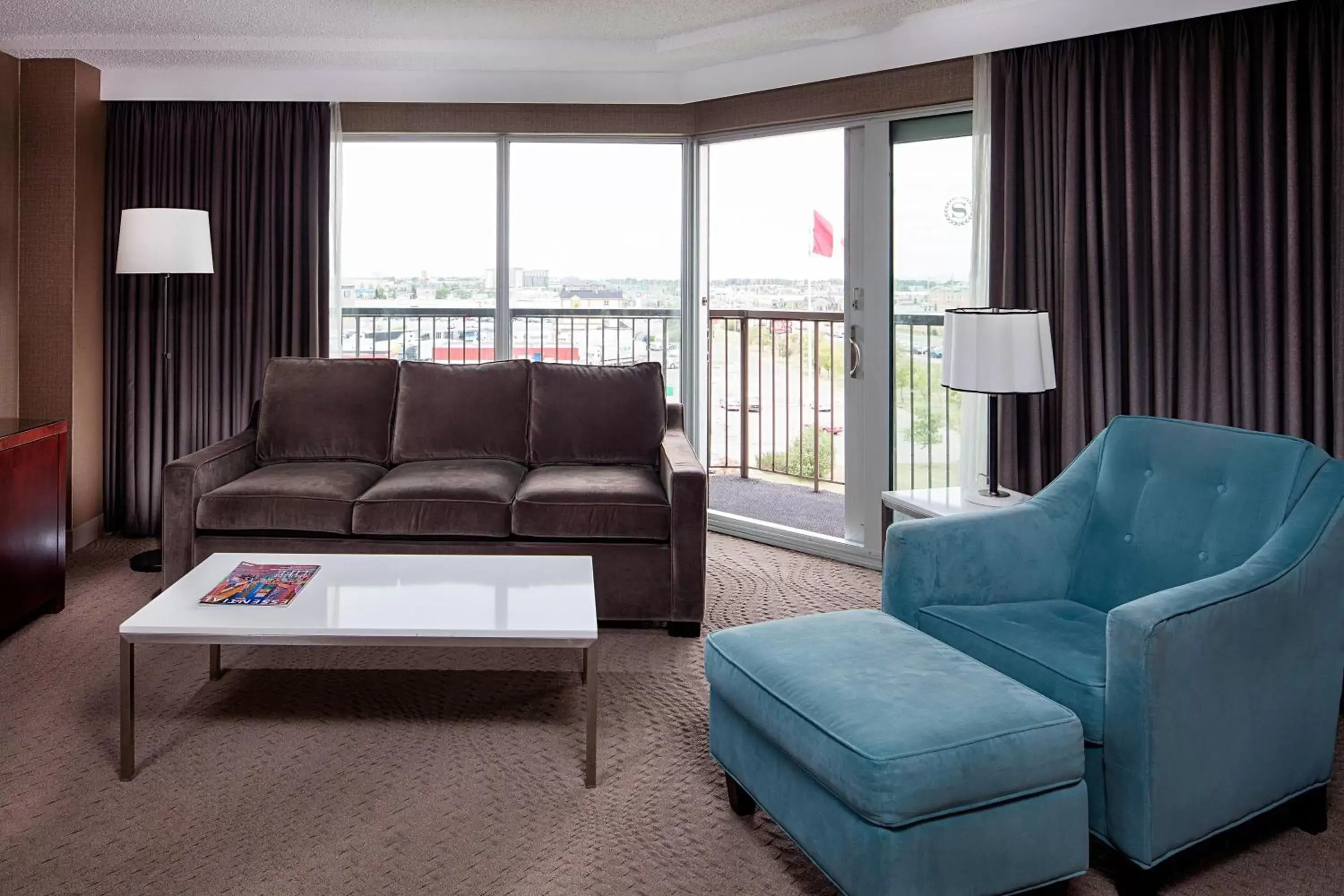 Bedroom, Seating Area in Sheraton Cavalier Calgary Hotel