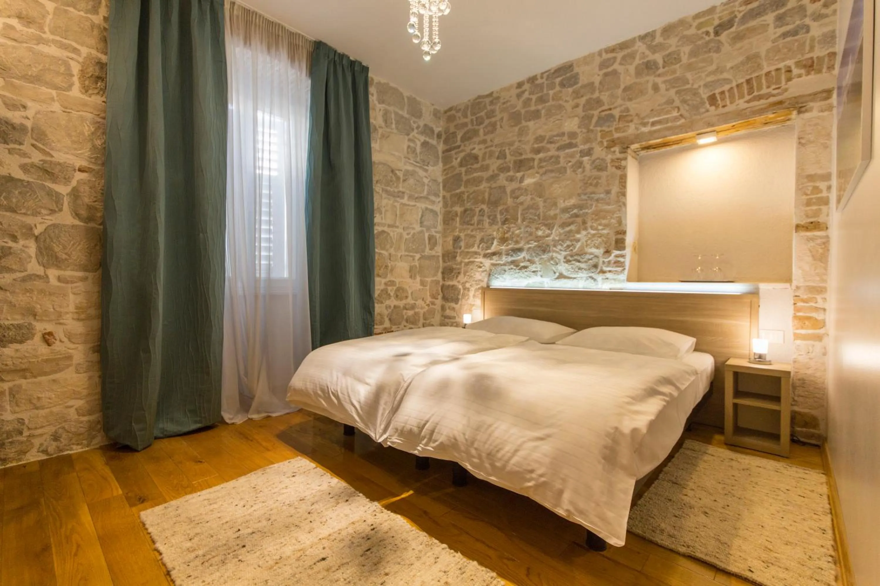 Bed in Tifani Luxury Rooms